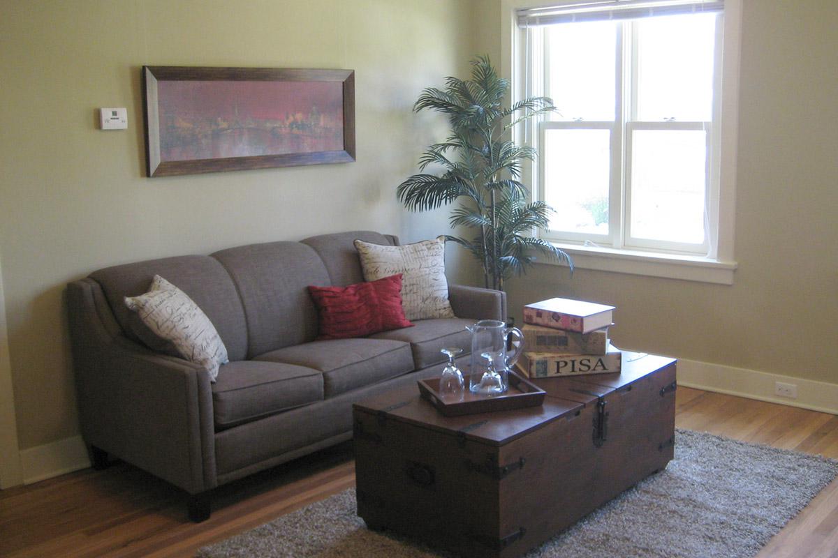 a living room filled with furniture and a window