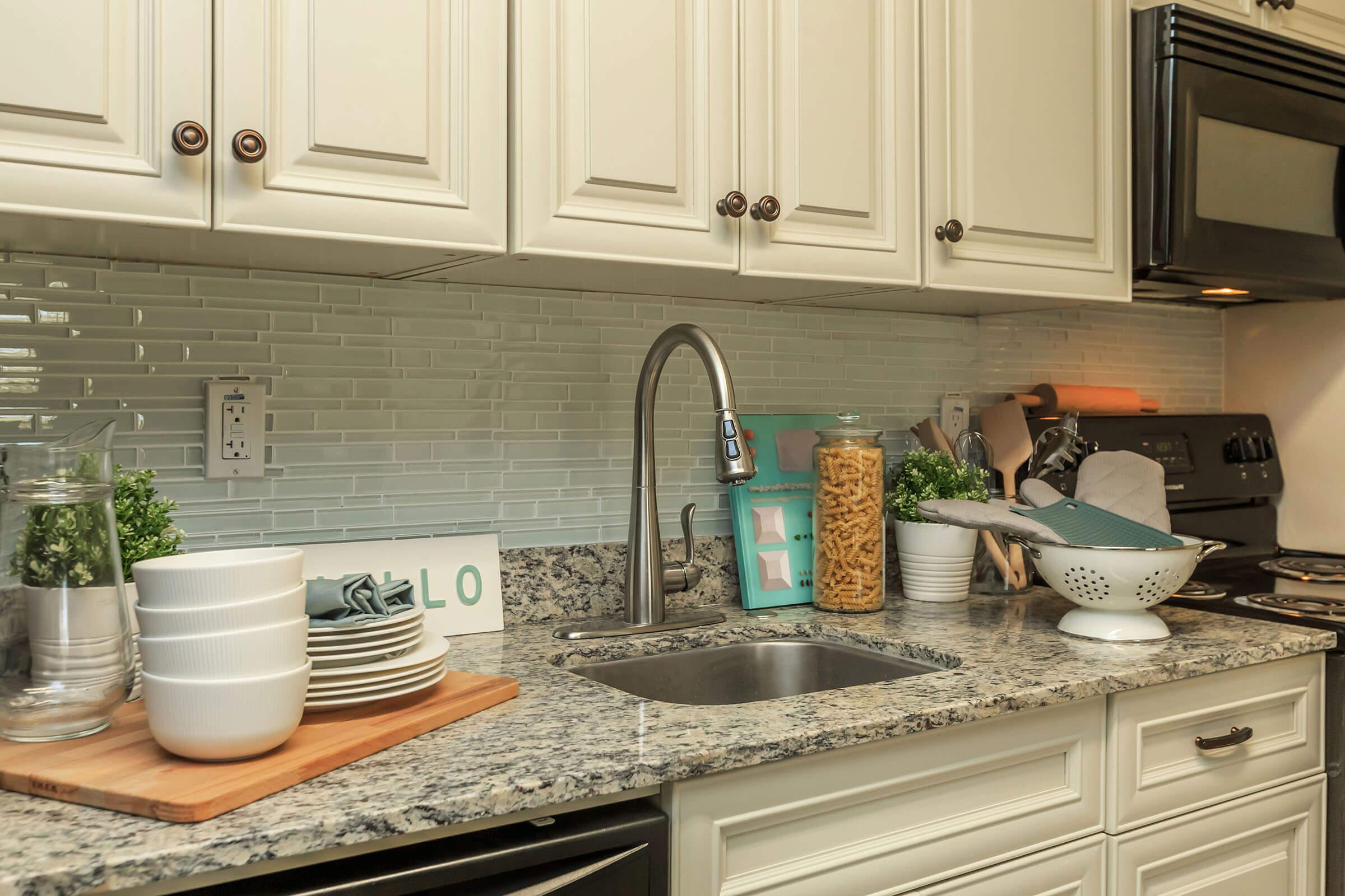 a kitchen with a stove a sink and a microwave