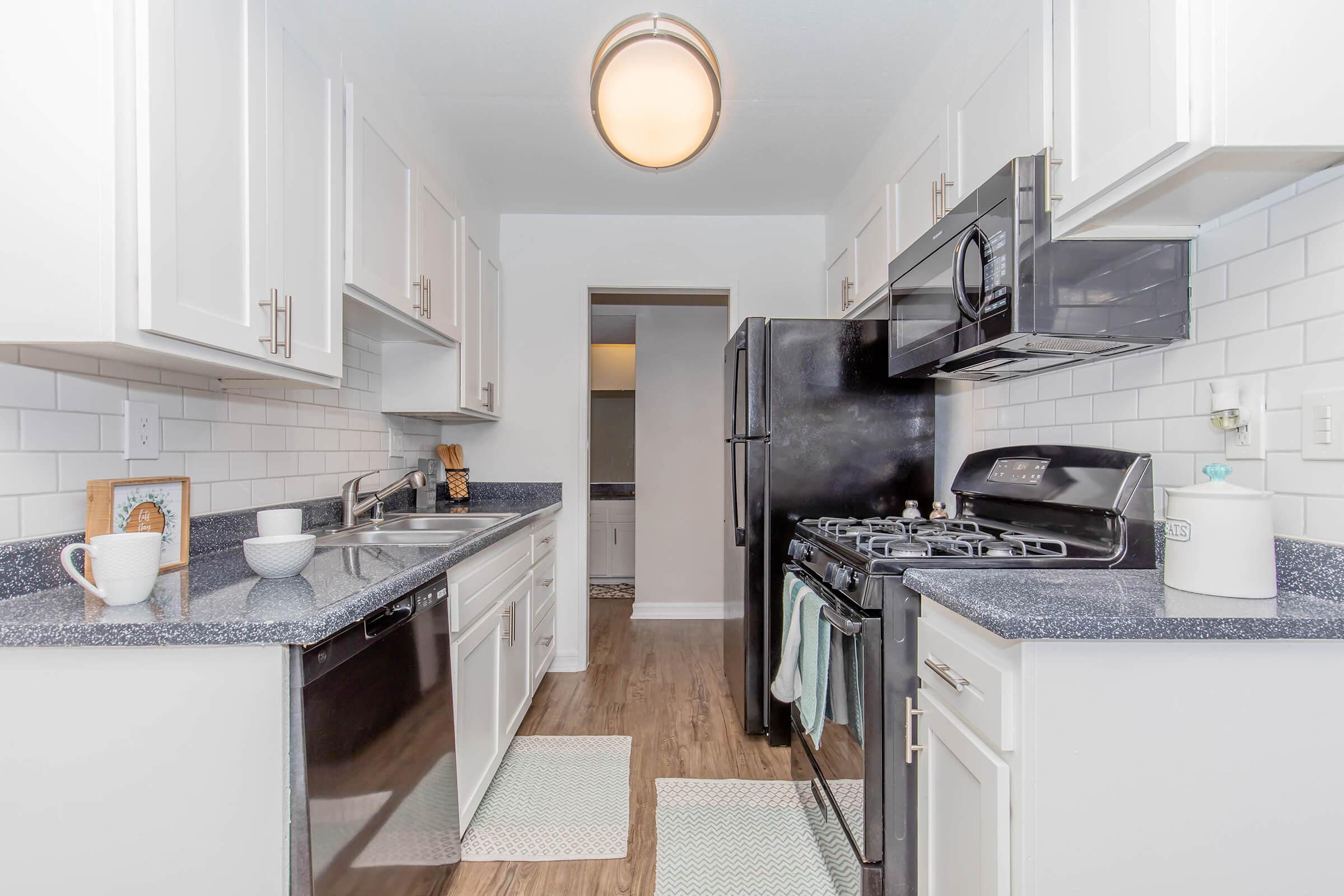 a kitchen with a stove sink and refrigerator