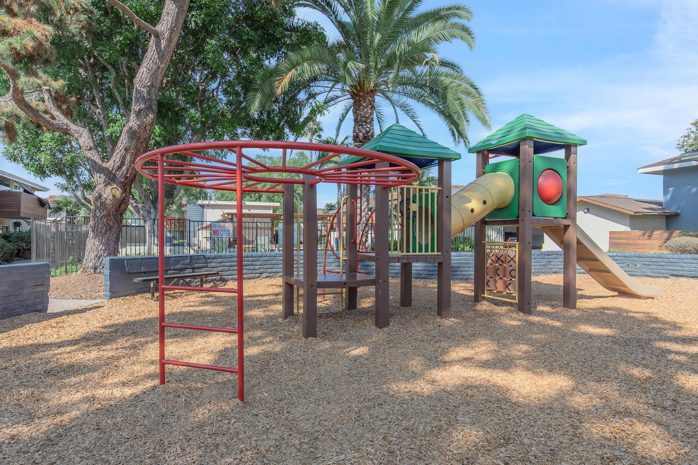 Apartments For Rent In Oceanside, CA - The Dylan - Children's Playground With A Bench