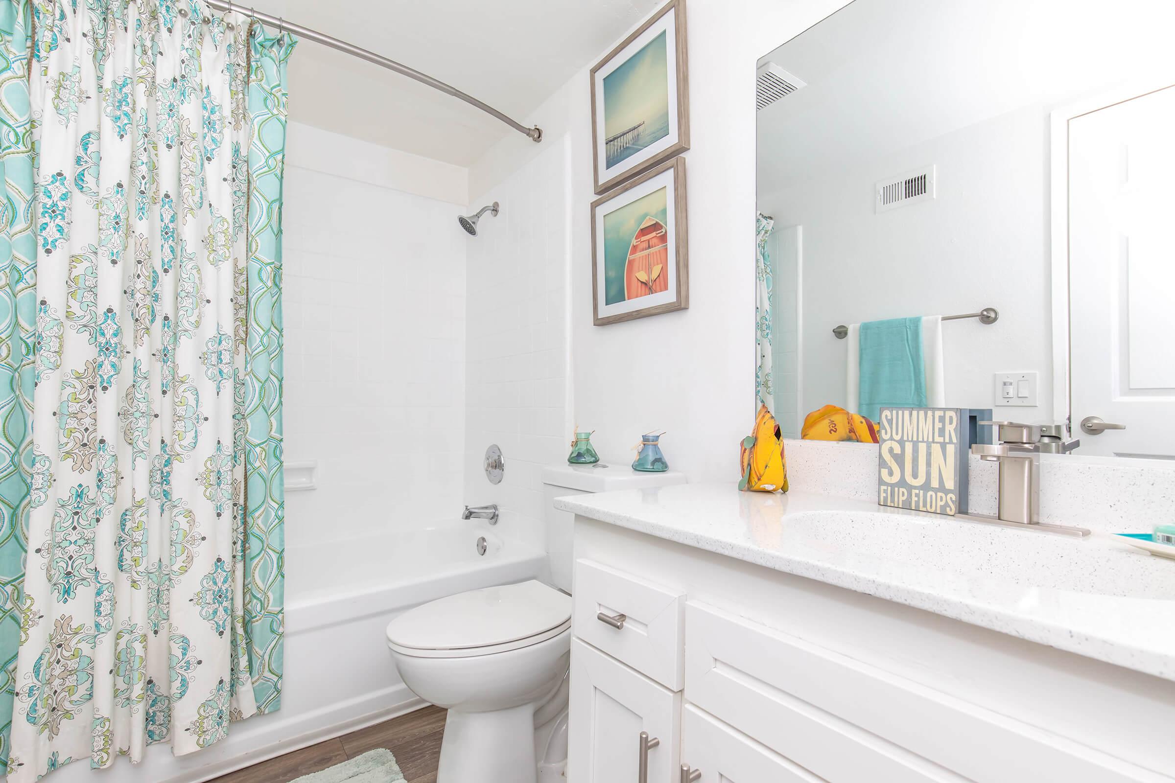 a shower curtain next to a sink