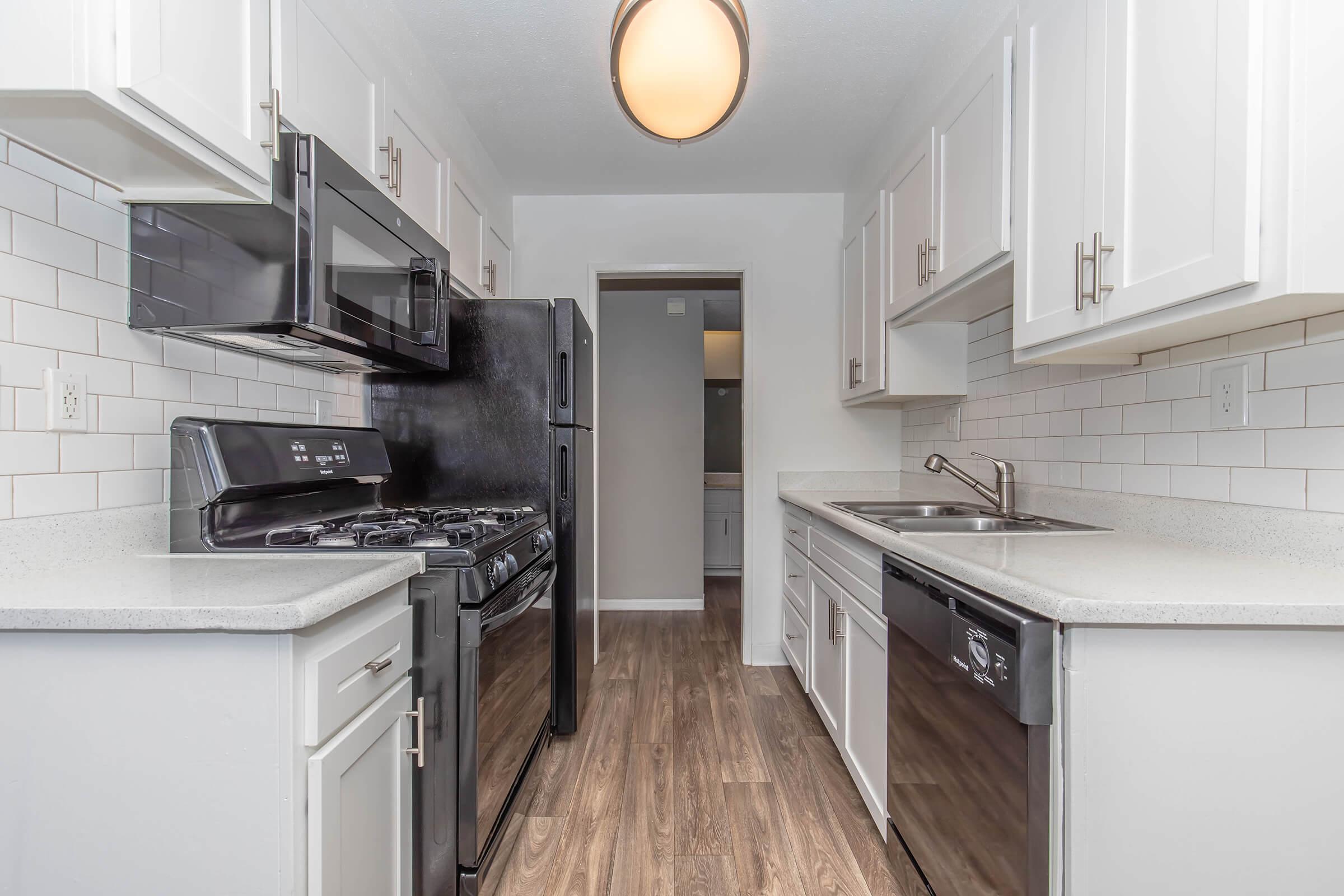 a kitchen with a stove sink and refrigerator