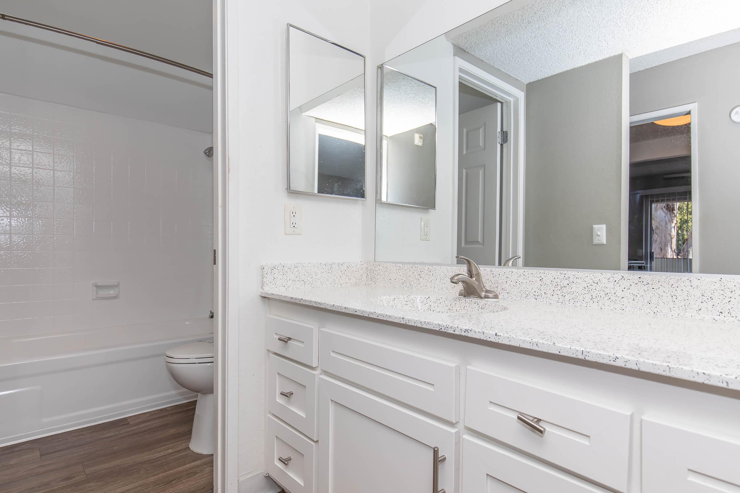 a kitchen with a sink and a mirror