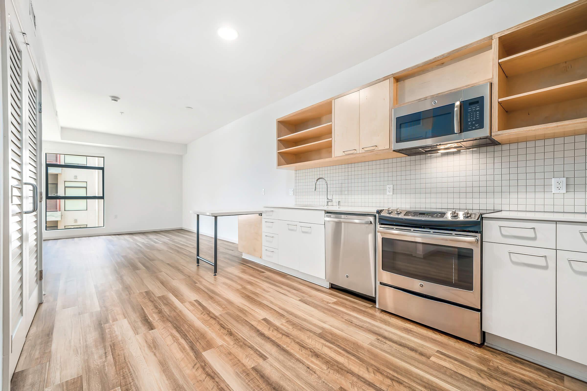 a kitchen area with a building in the background