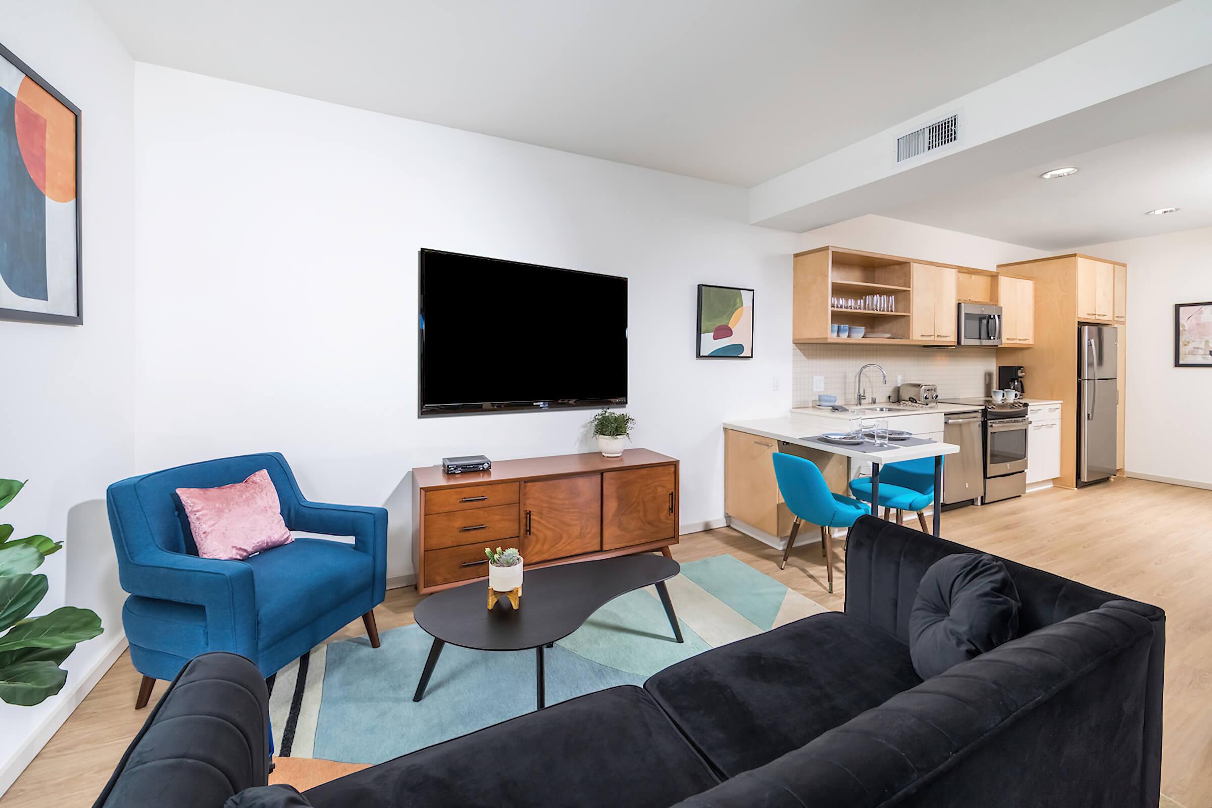 a living room filled with furniture and a flat screen tv