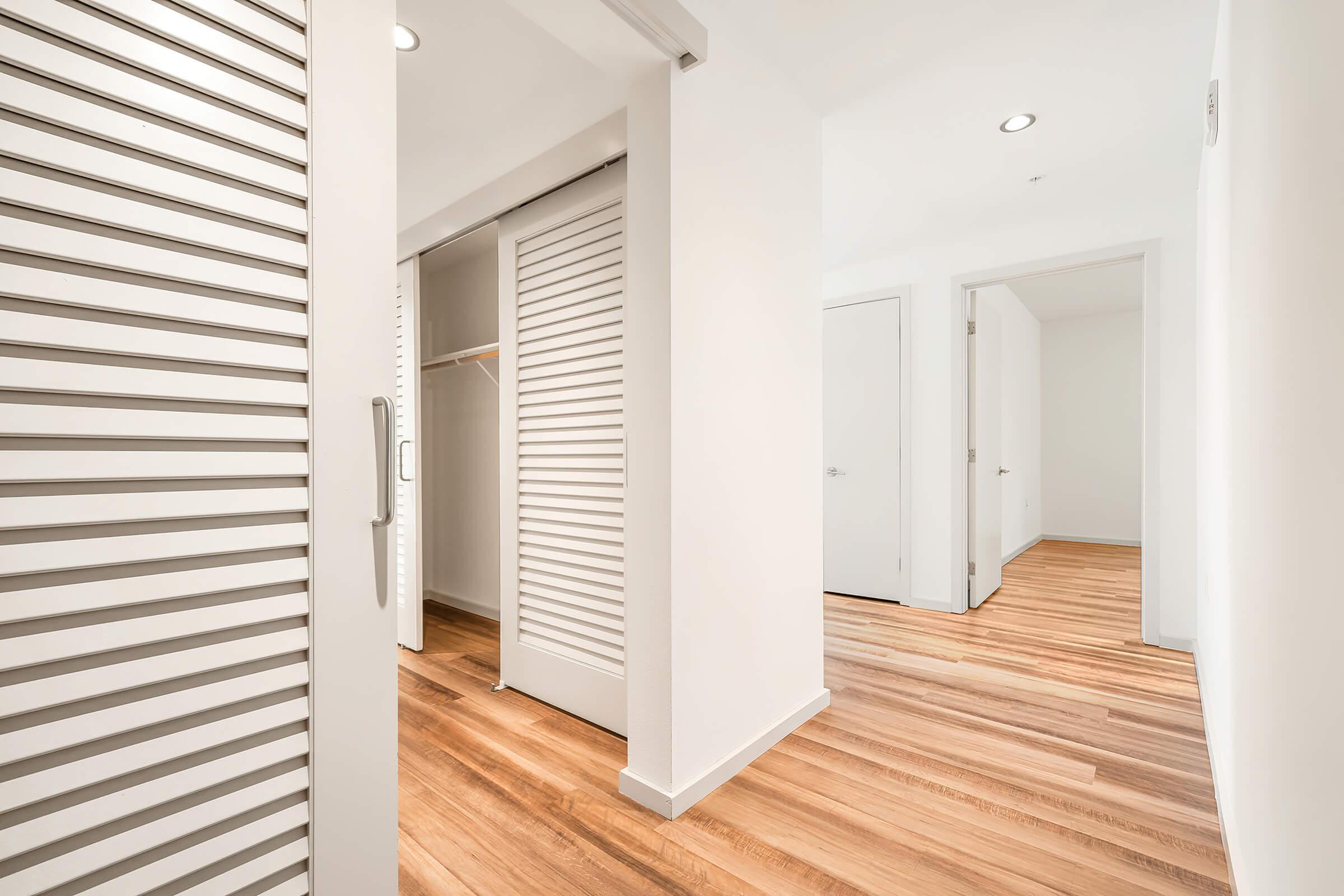unfurnished hallways and bedroom with wooden floors
