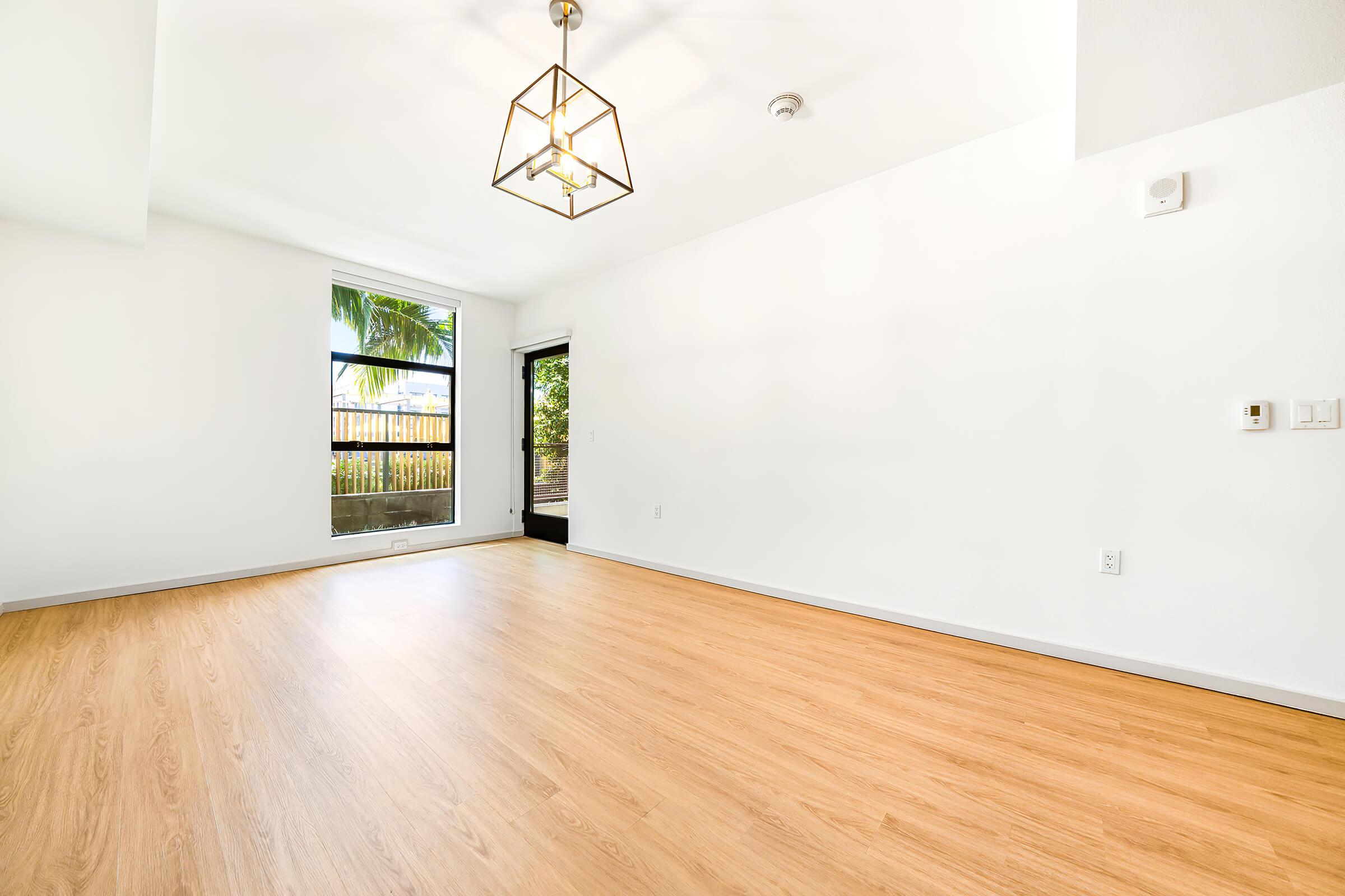vacant living room with wooden floors