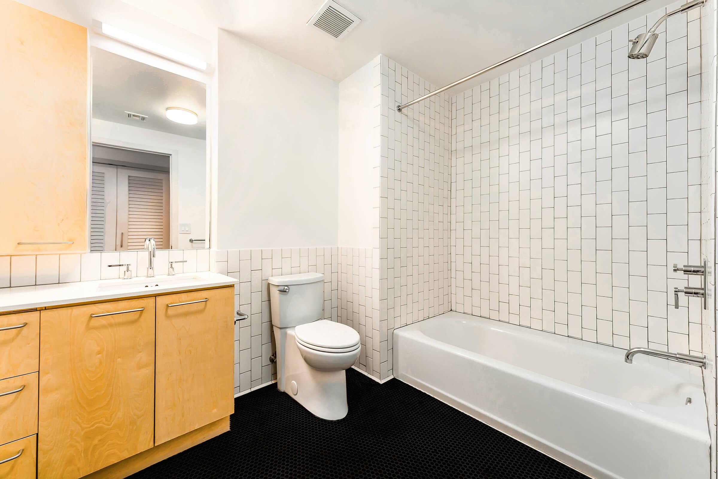 unfurnished bathroom with white shower tiling