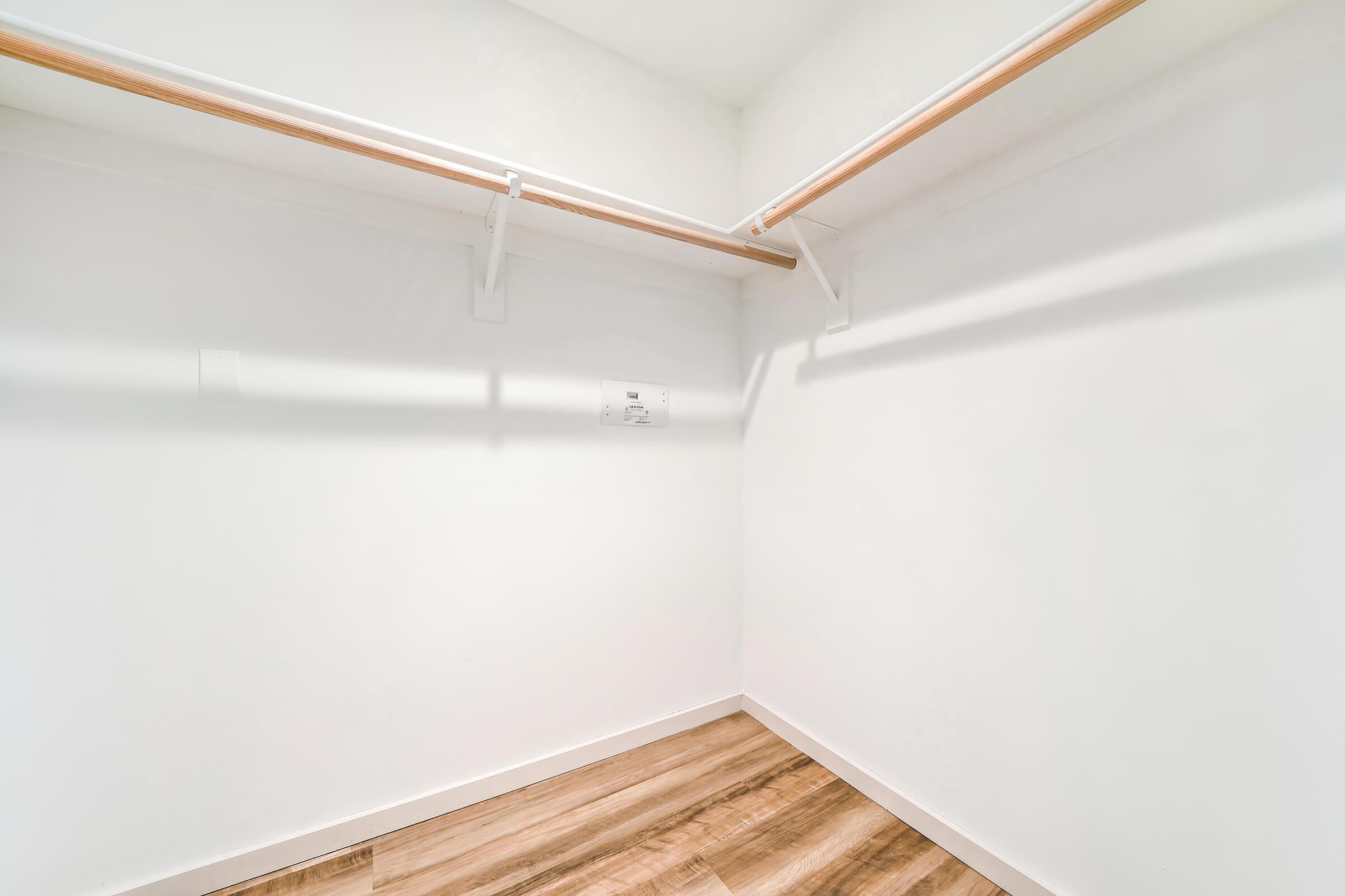 unfurnished walk-in closet with wooden floors