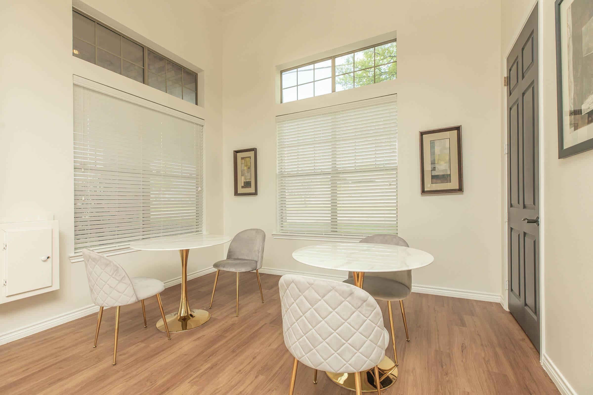 a living room filled with furniture and a large window