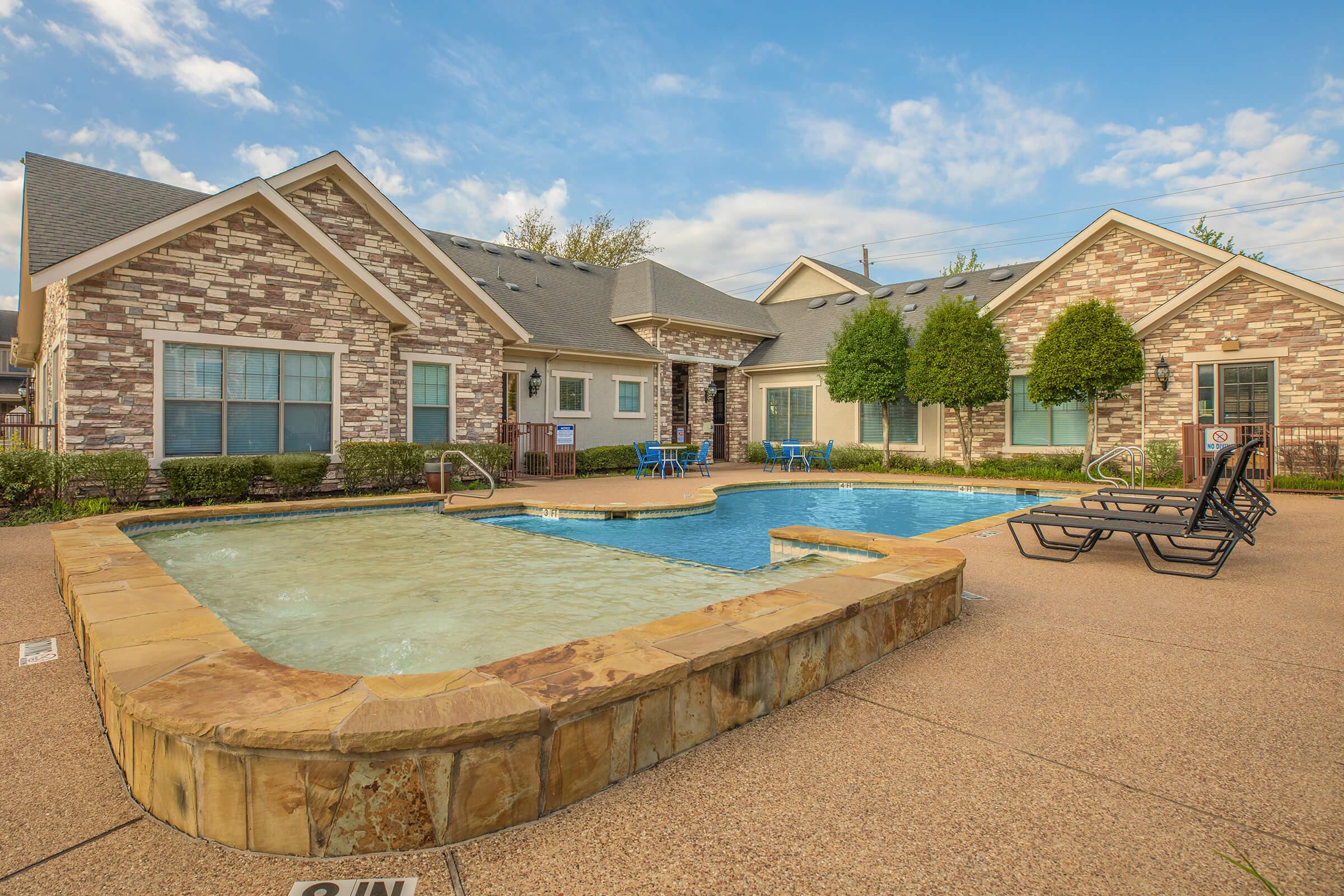 a house with a pool in front of a building