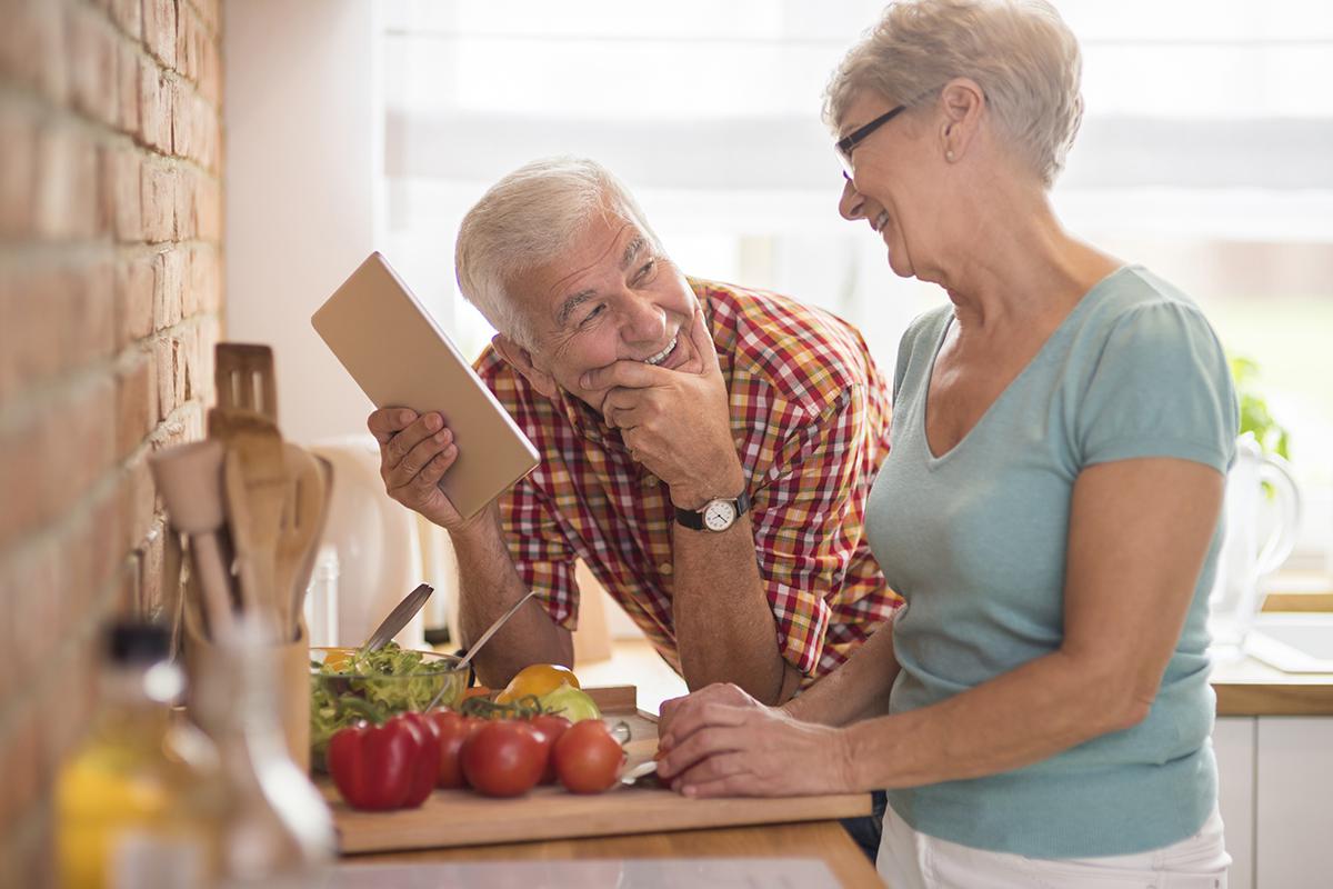 a man and a woman standing in front of a fruit