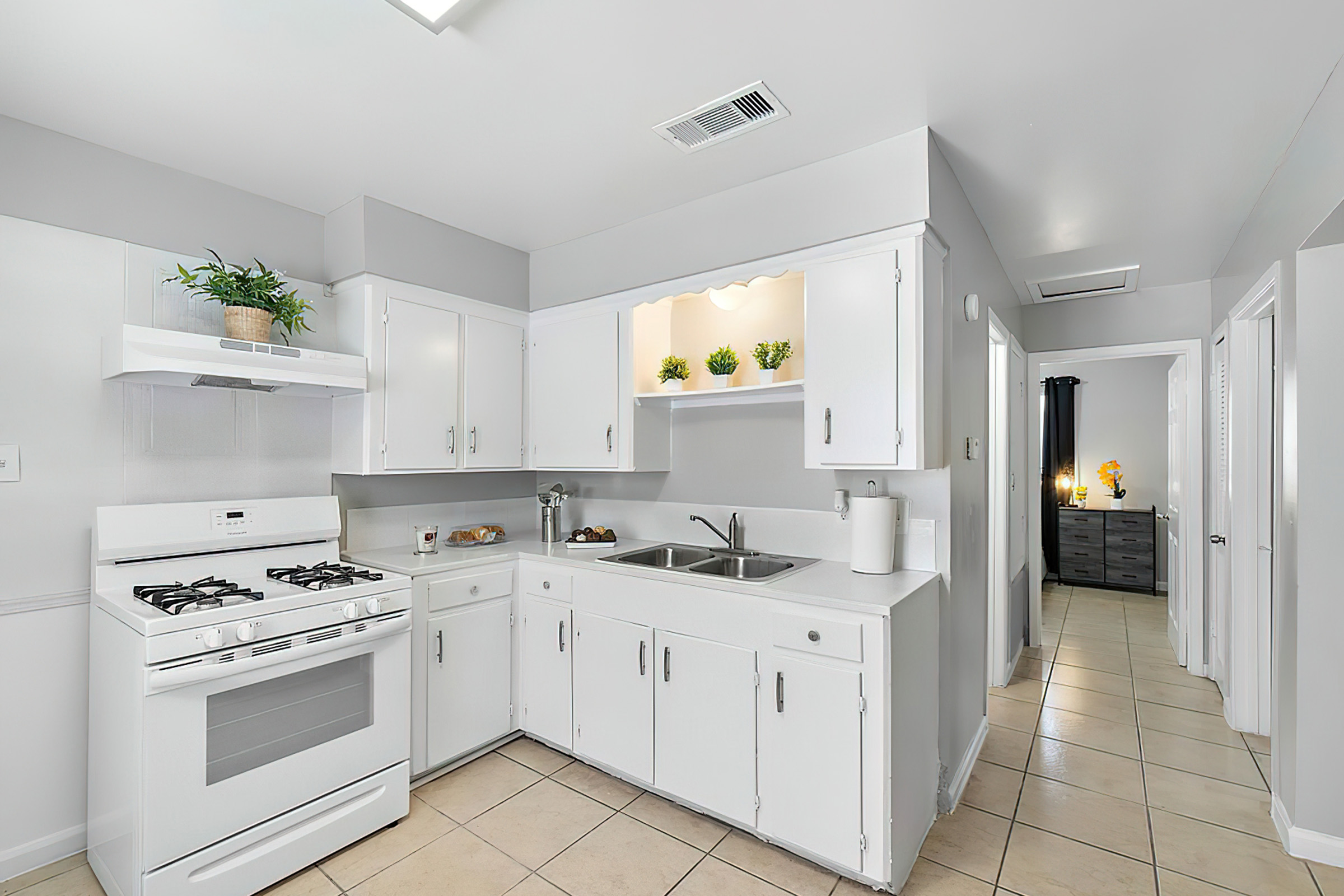 a kitchen with a sink and a mirror