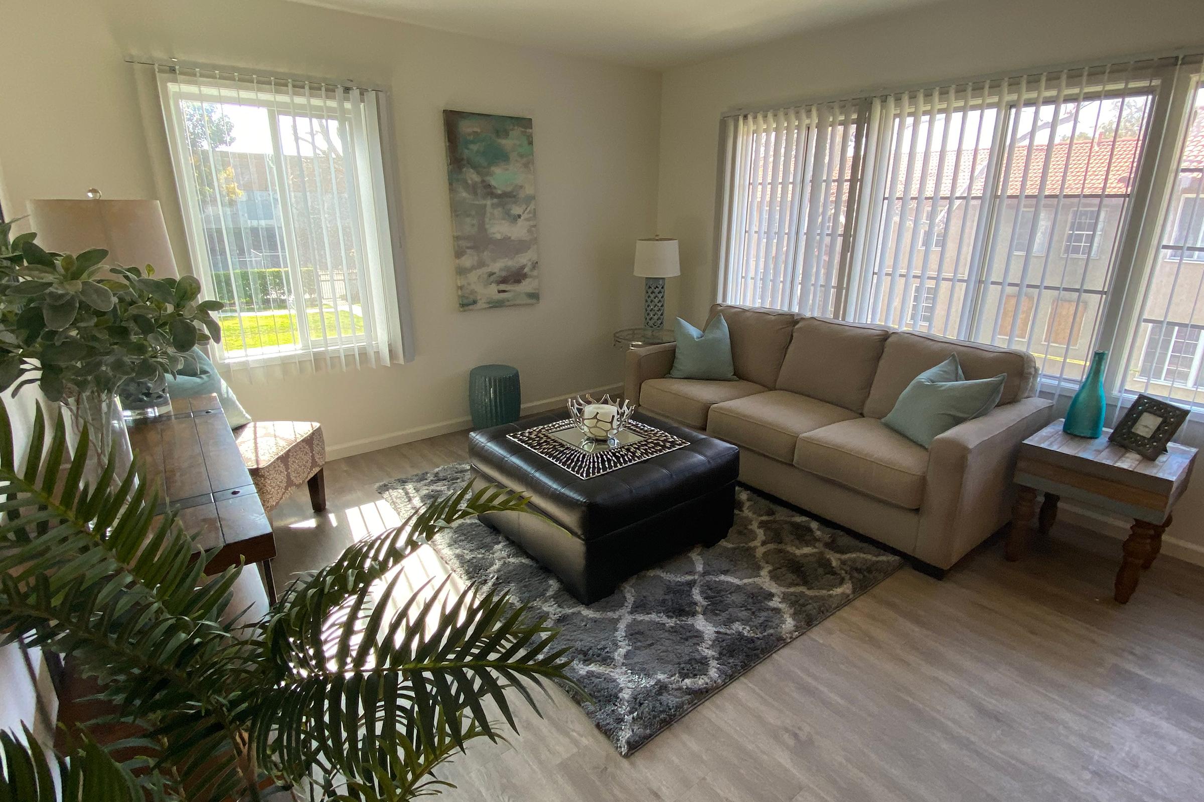 a living room filled with furniture and a large window