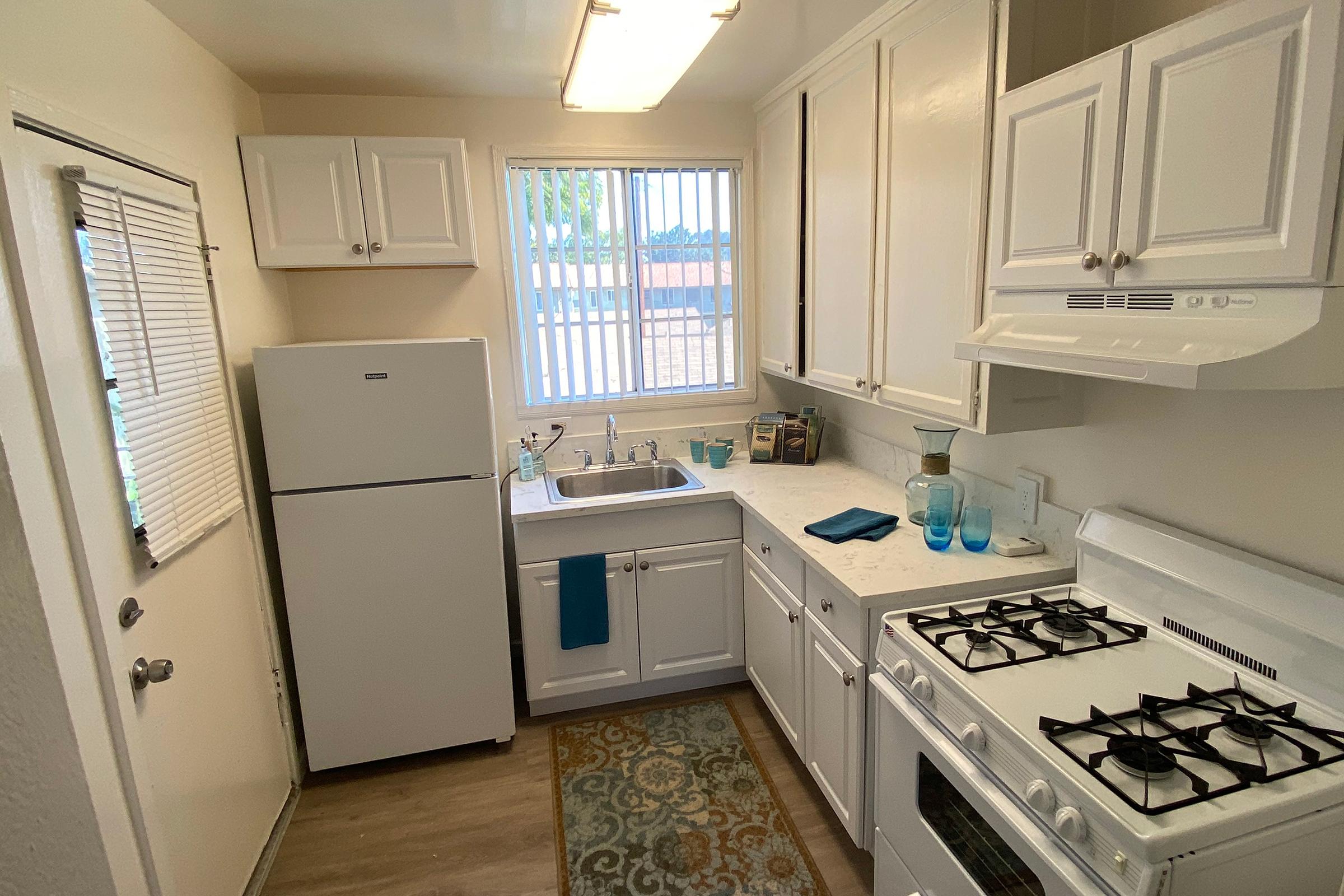 a stove top oven sitting inside of a kitchen