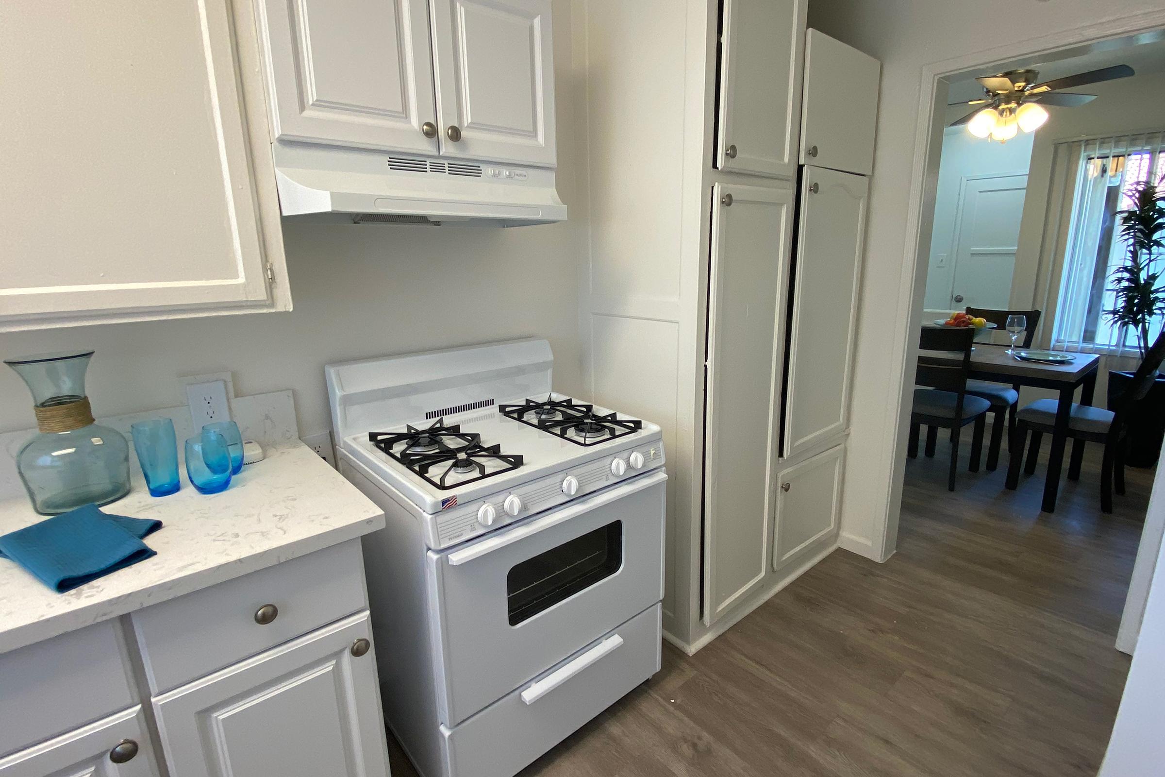 a stove top oven sitting inside of a kitchen