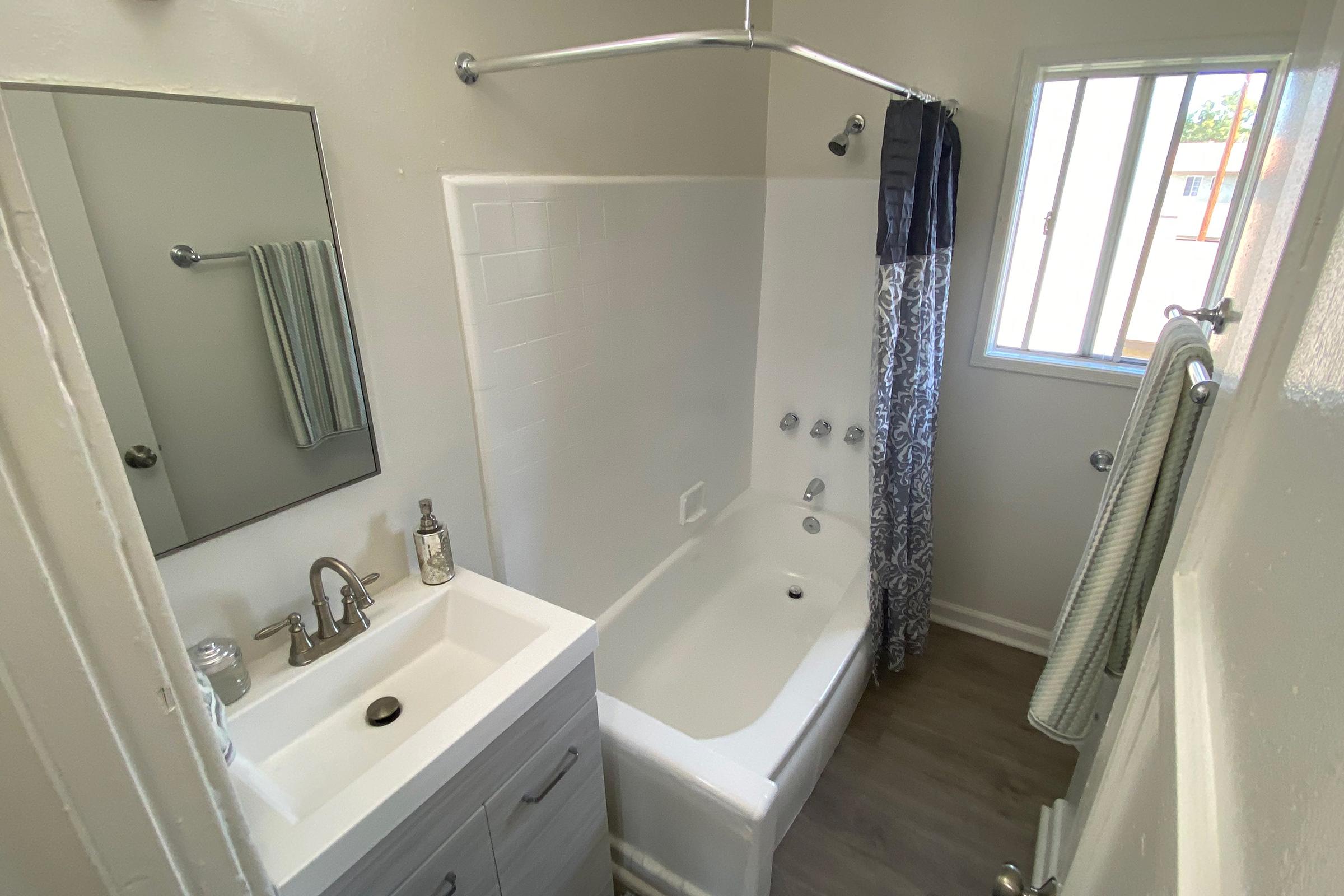 a shower that has a sink and a mirror