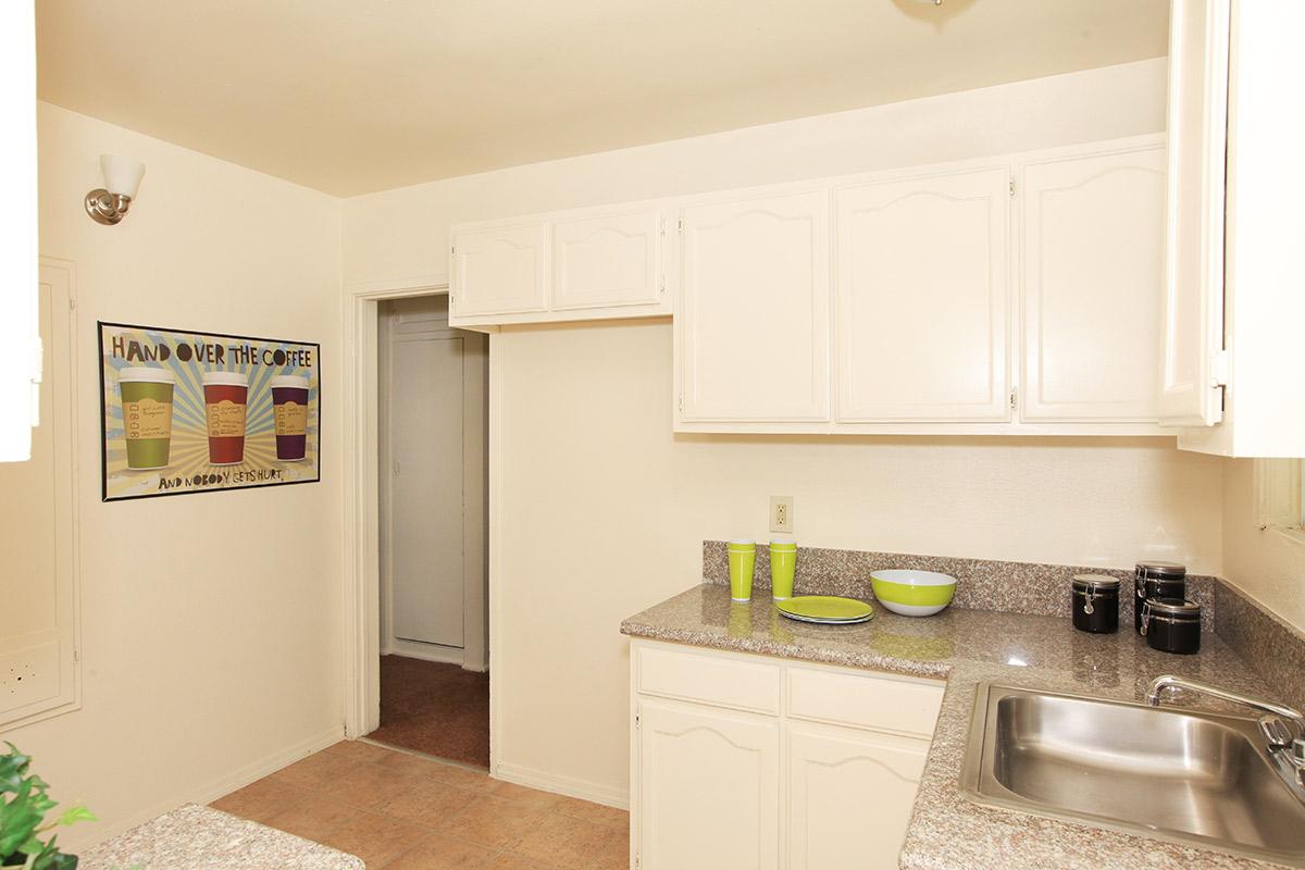 a kitchen with a sink and a refrigerator