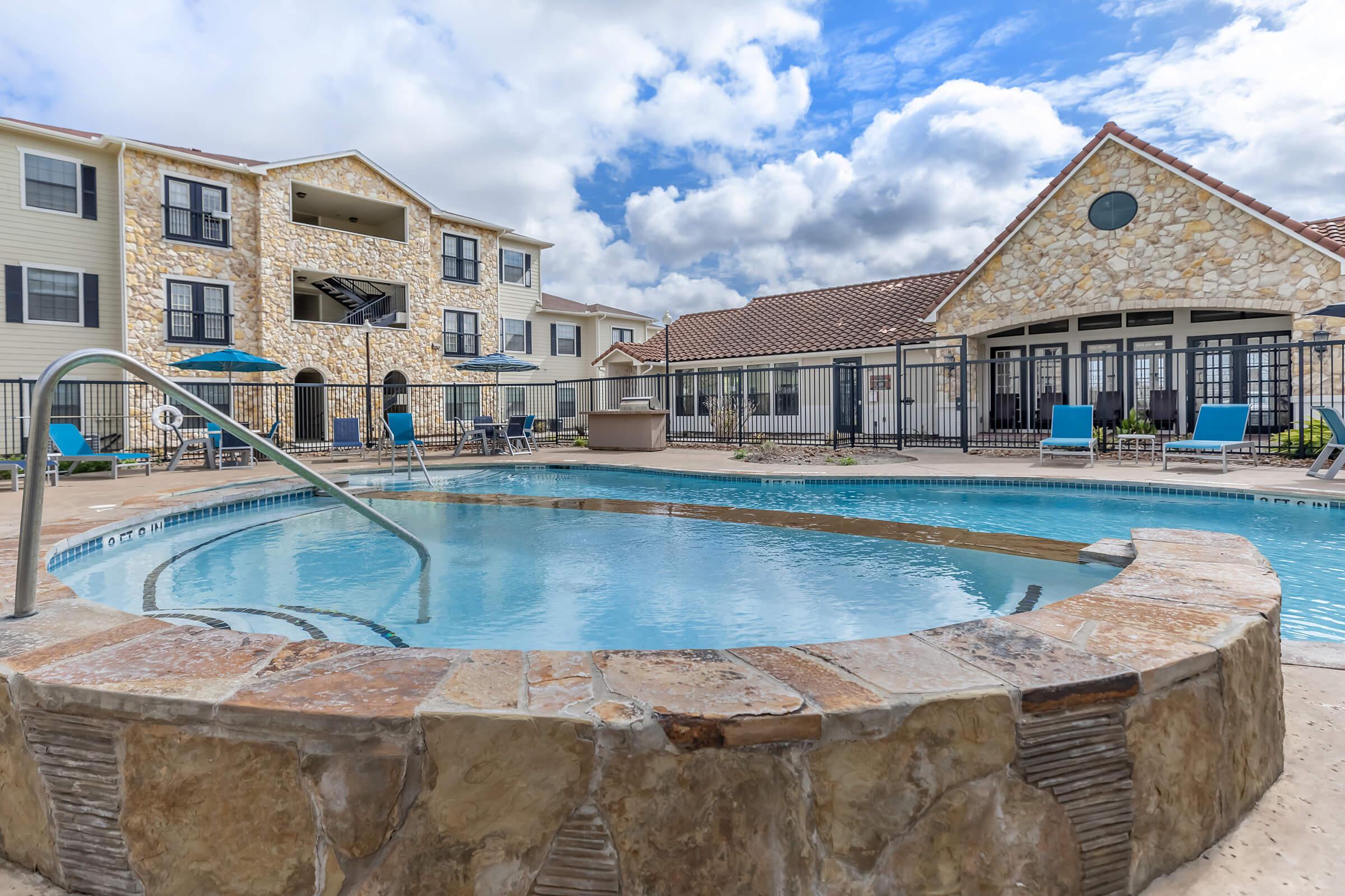 a large brick building with a pool in front of a house