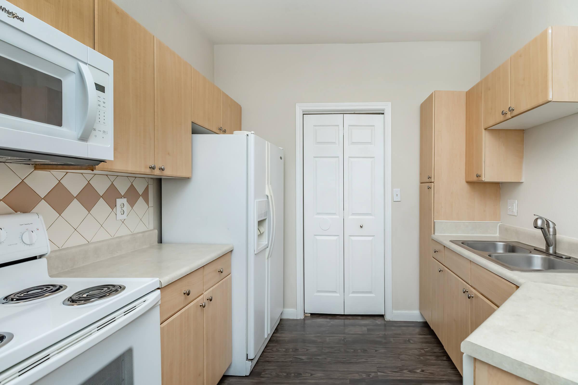 a kitchen with a stove sink and refrigerator