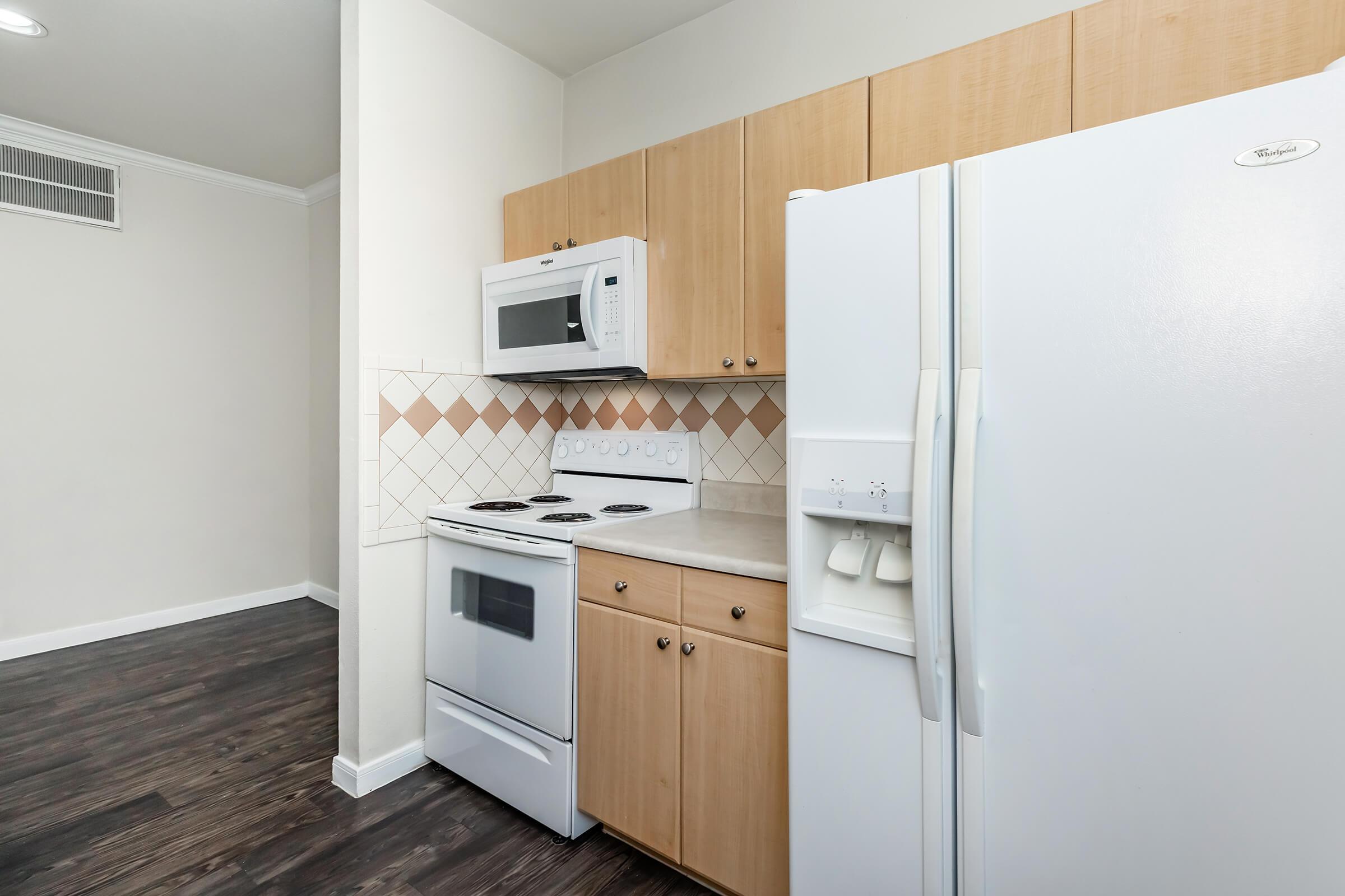 a kitchen with a stove and a refrigerator