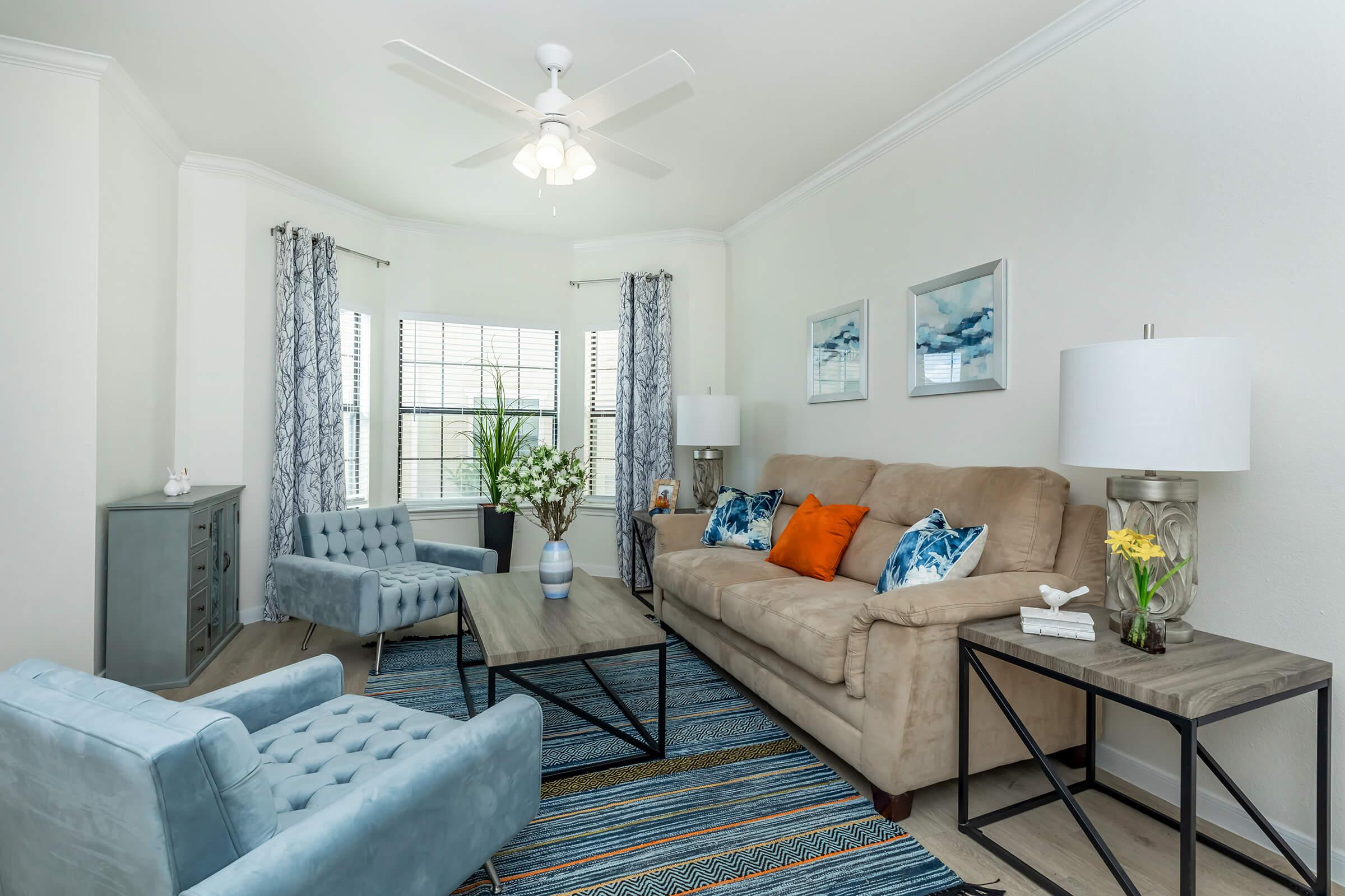 a living room filled with furniture and a large window