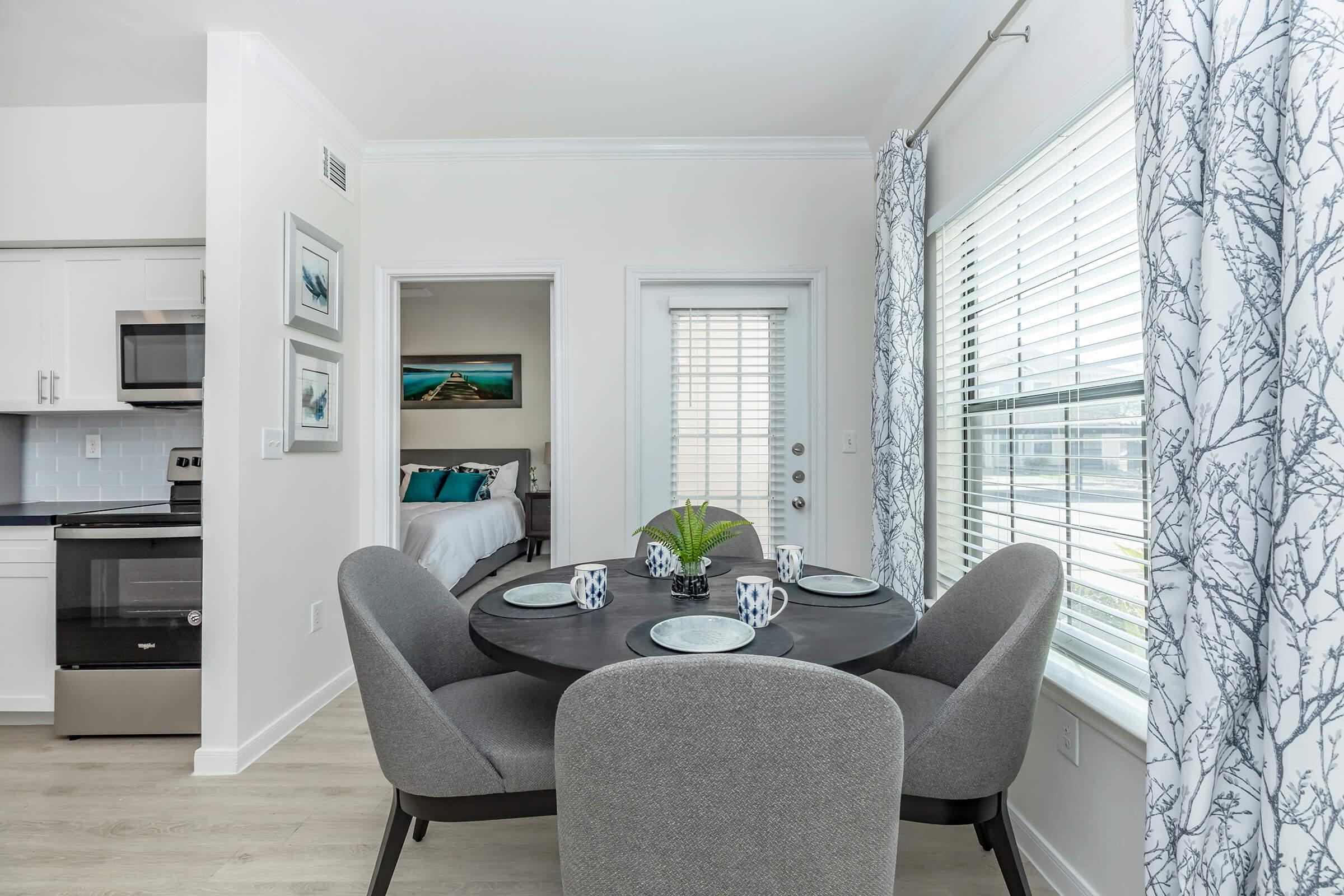 a living room filled with furniture and a large window