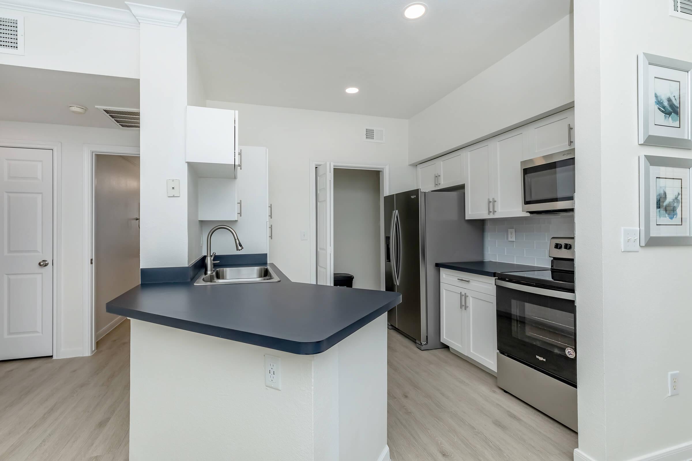 a kitchen with a stove and a refrigerator