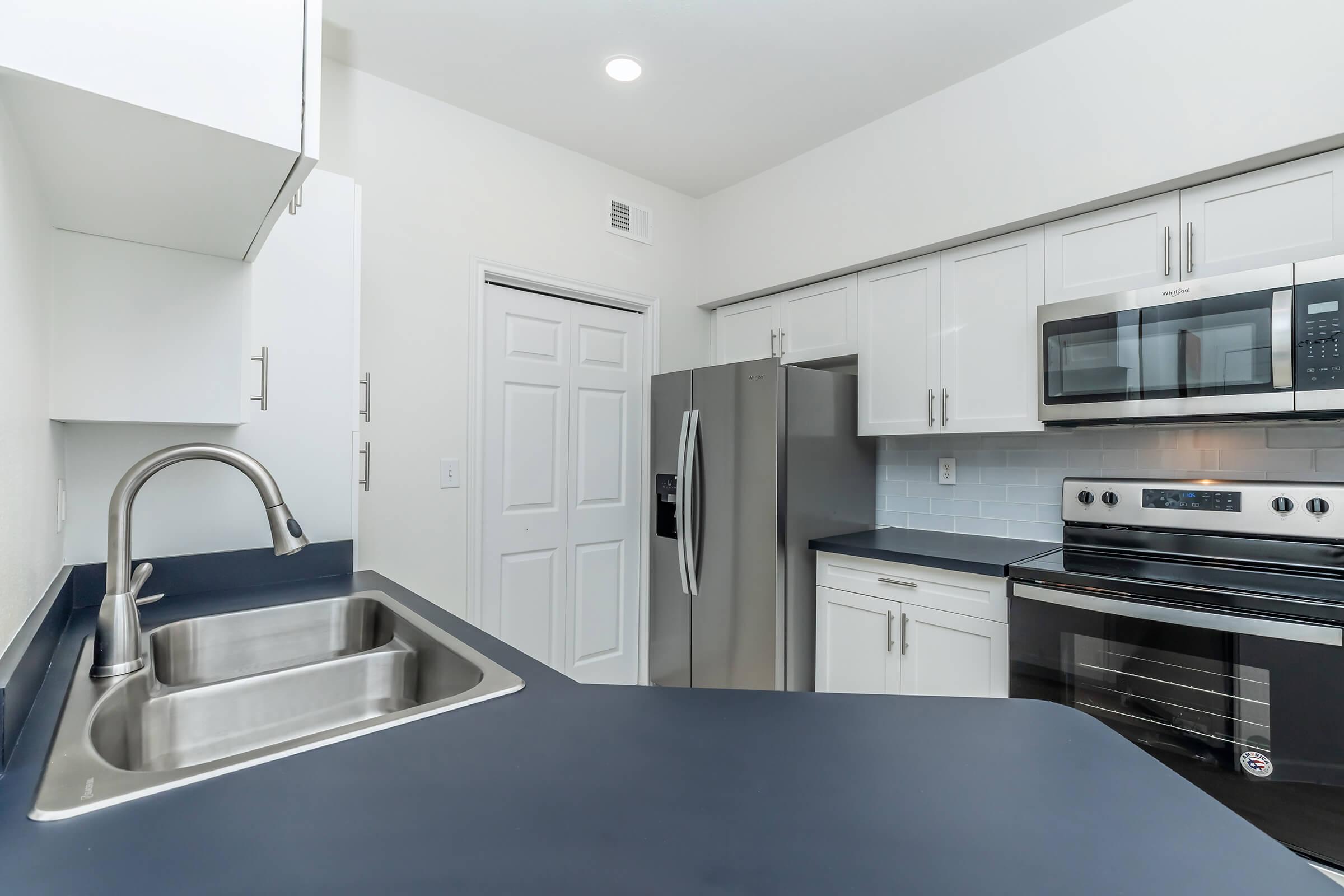 a kitchen with a stainless steel sink