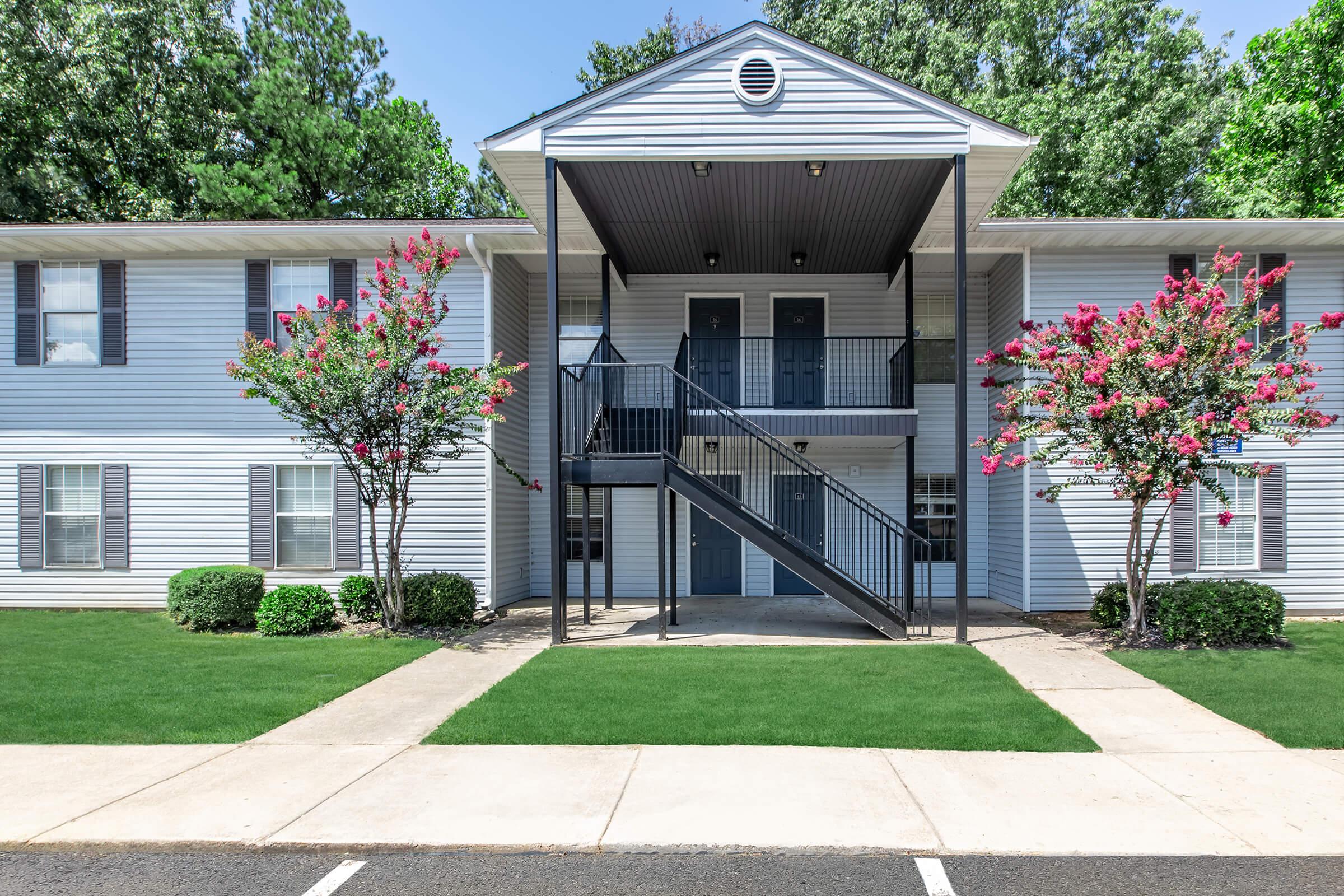 a house with a lawn in front of a building