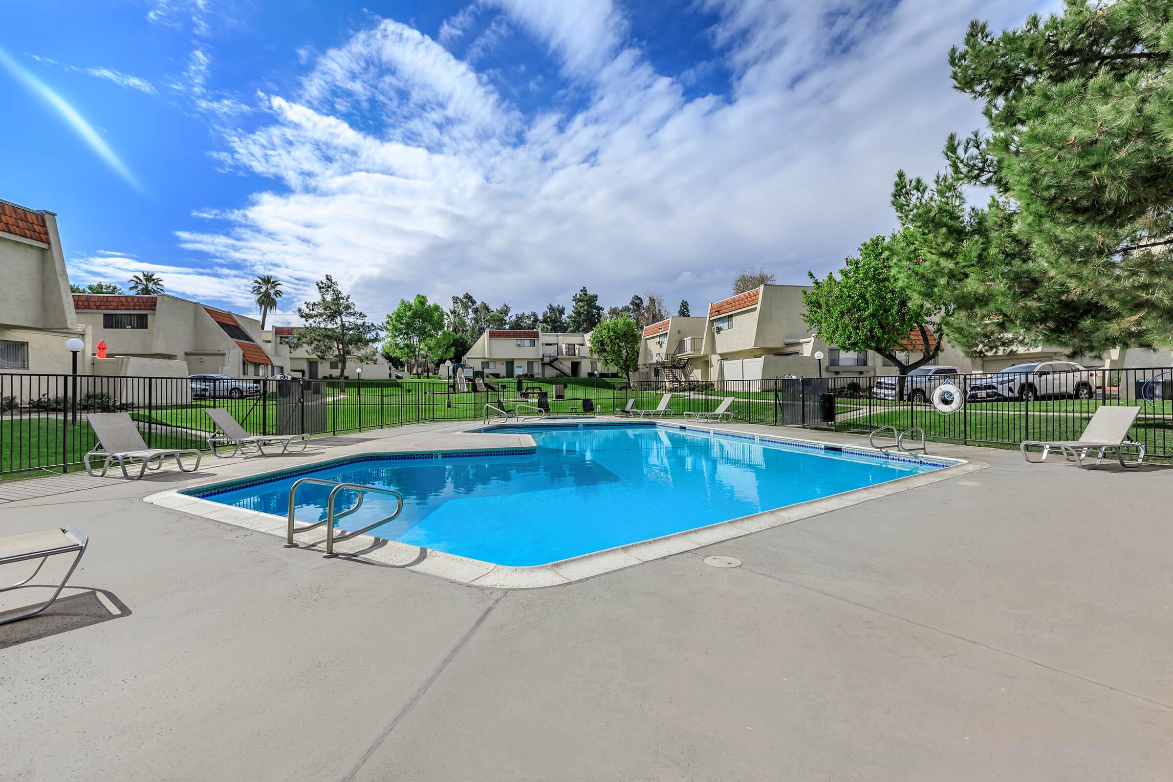 Brookside Park Apartments community pool with green grass