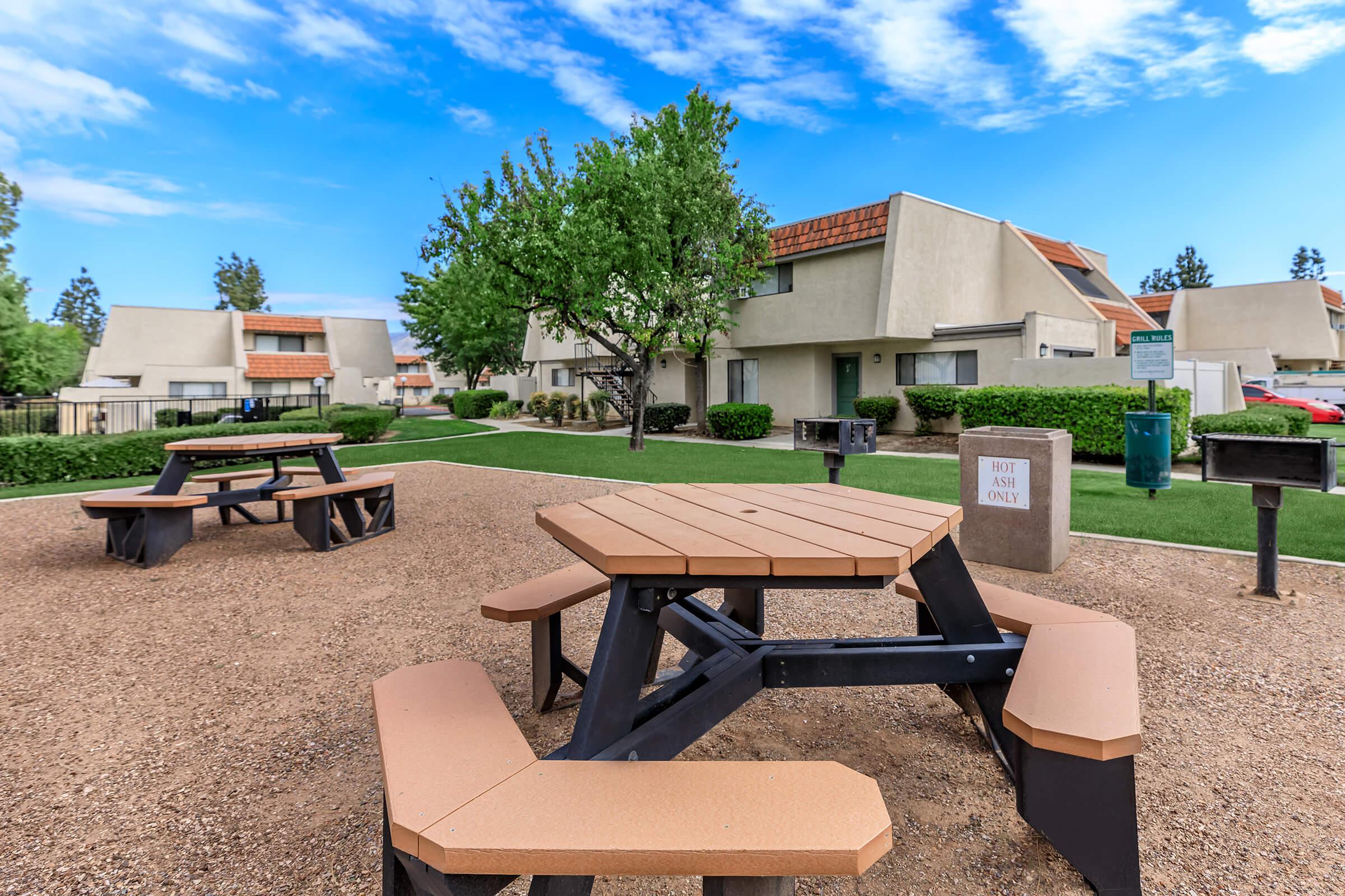 wooden picnic tables with barbecues