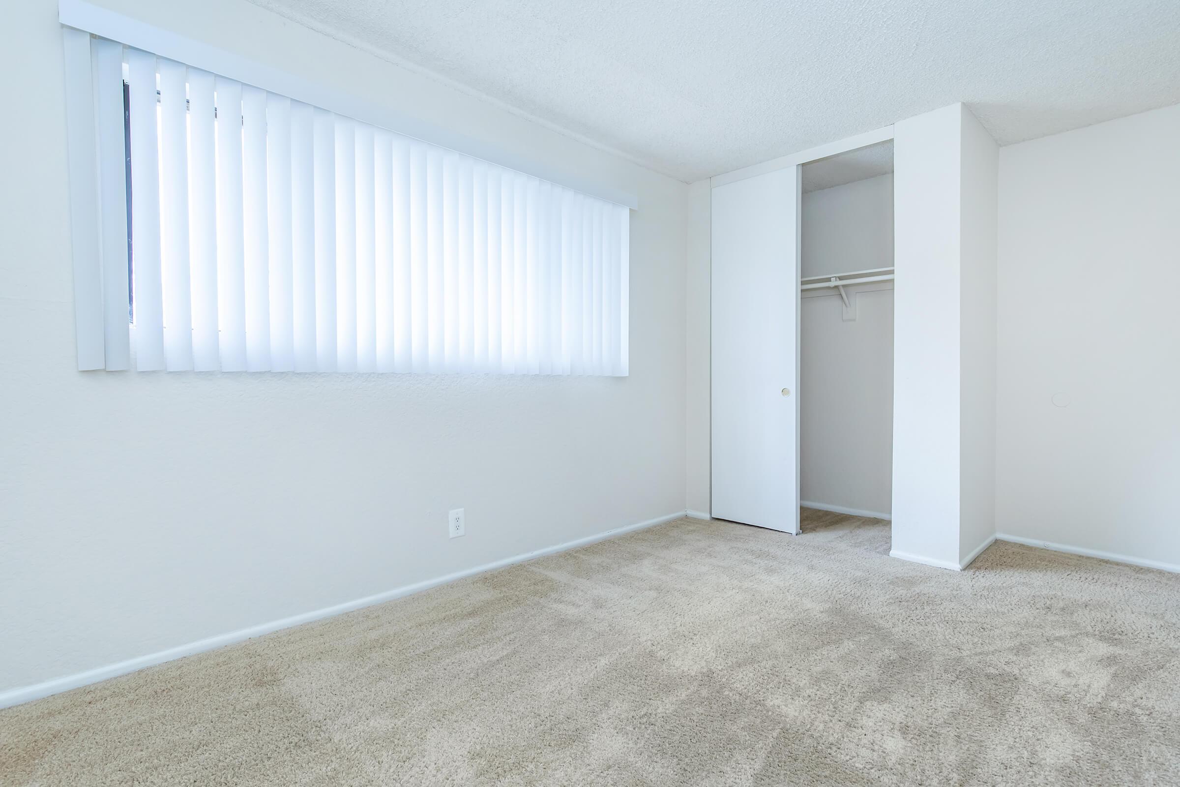 carpeted bedroom with sliding closet doors