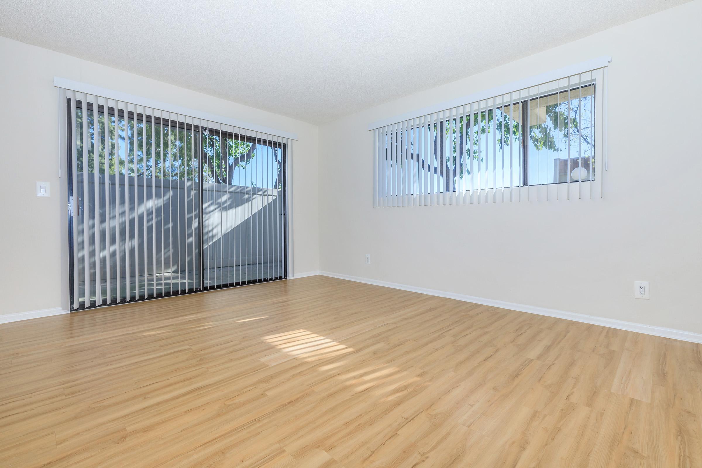 vacant living room with wooden floors