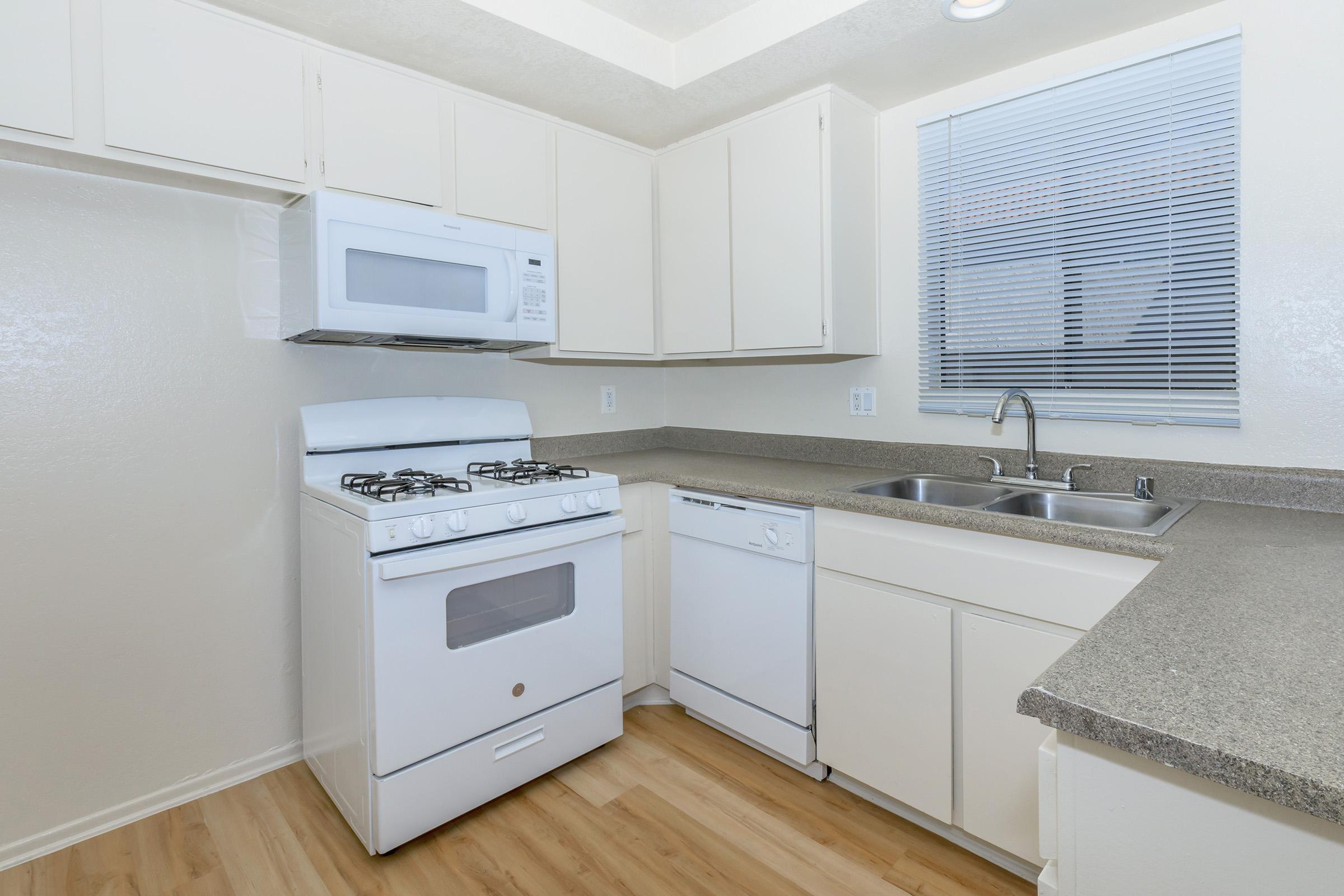 vacant kitchen with white appliances