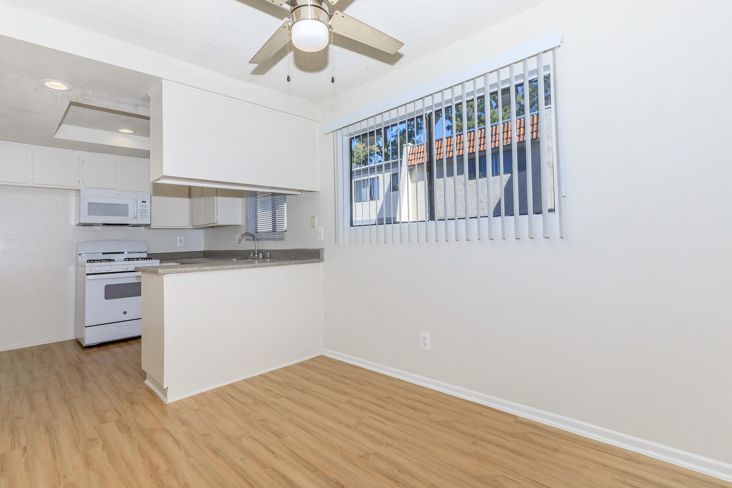 vacant dining room with a ceiling fan