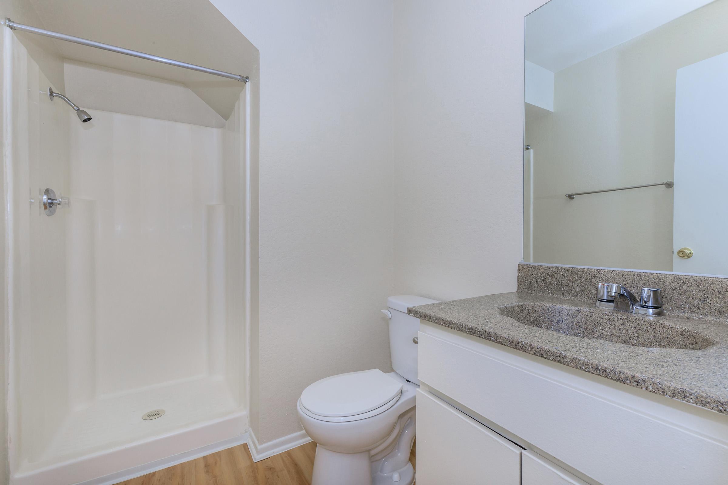 vacant bathroom with white cabinets