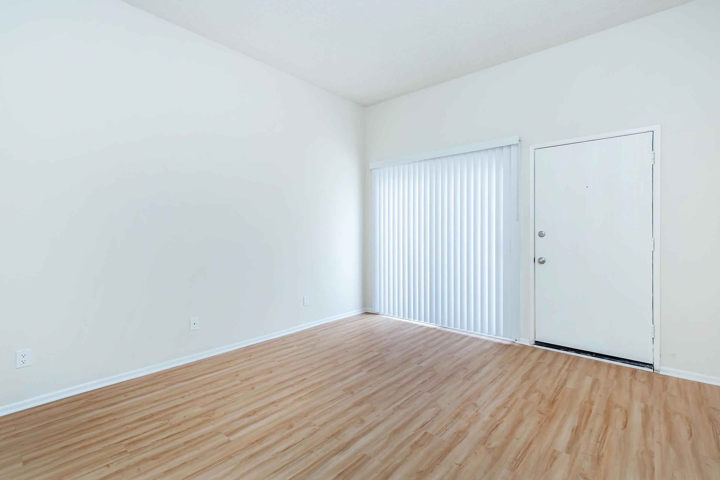 vacant living room with white window shades