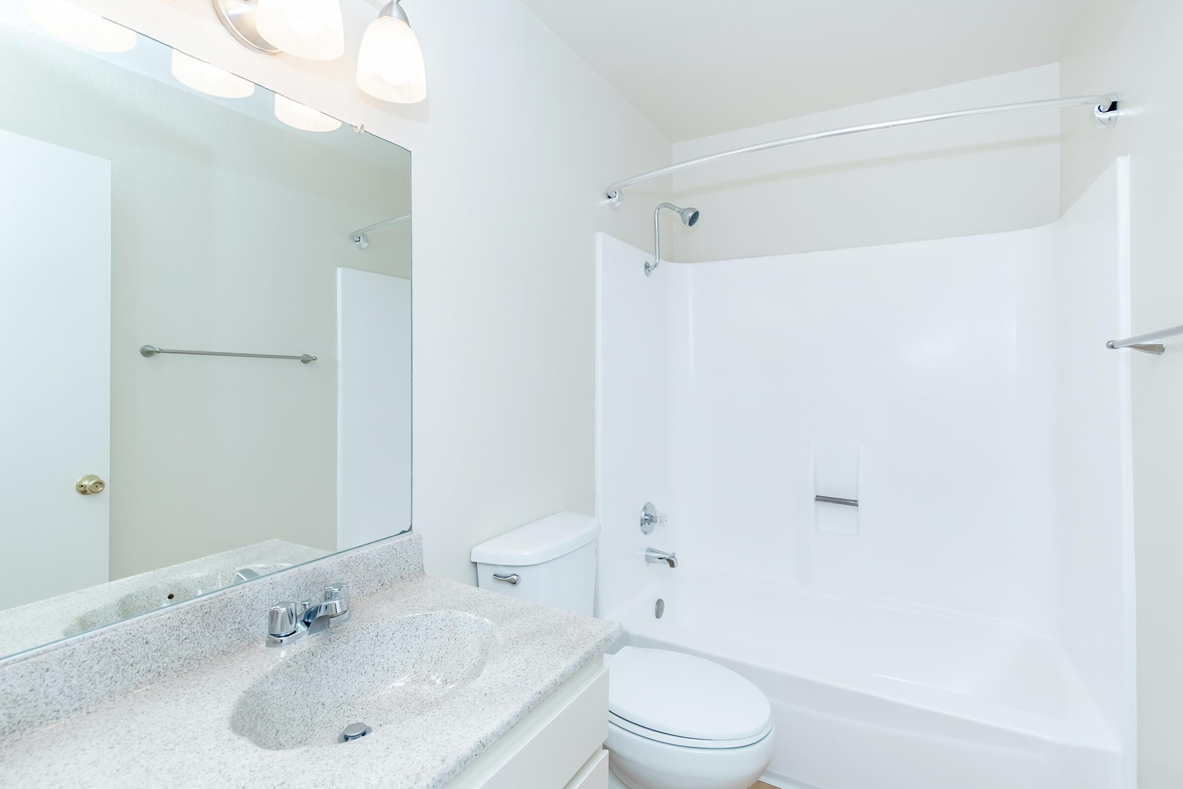 bathroom with white shower tiles