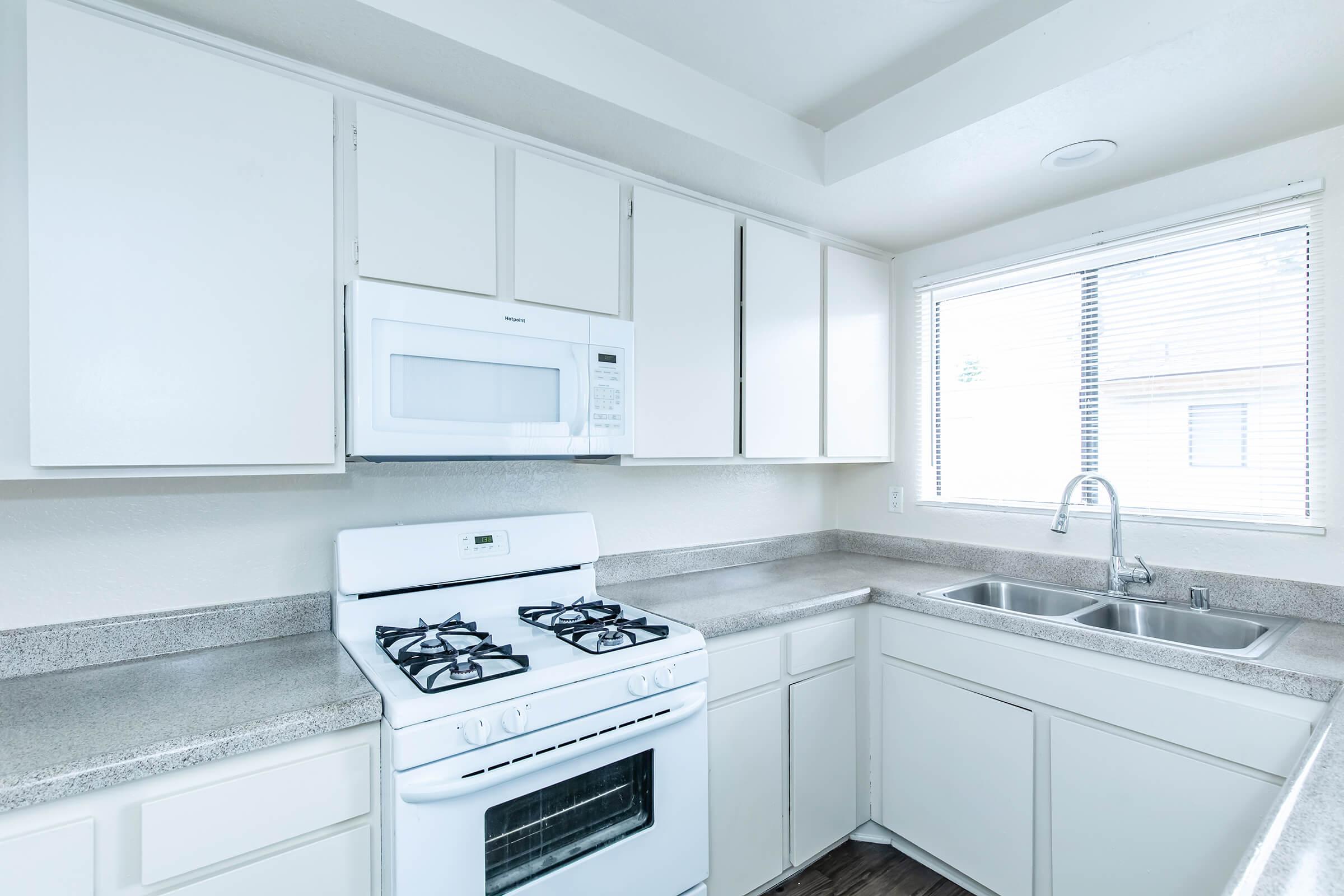 unfurnished kitchen with white appliances