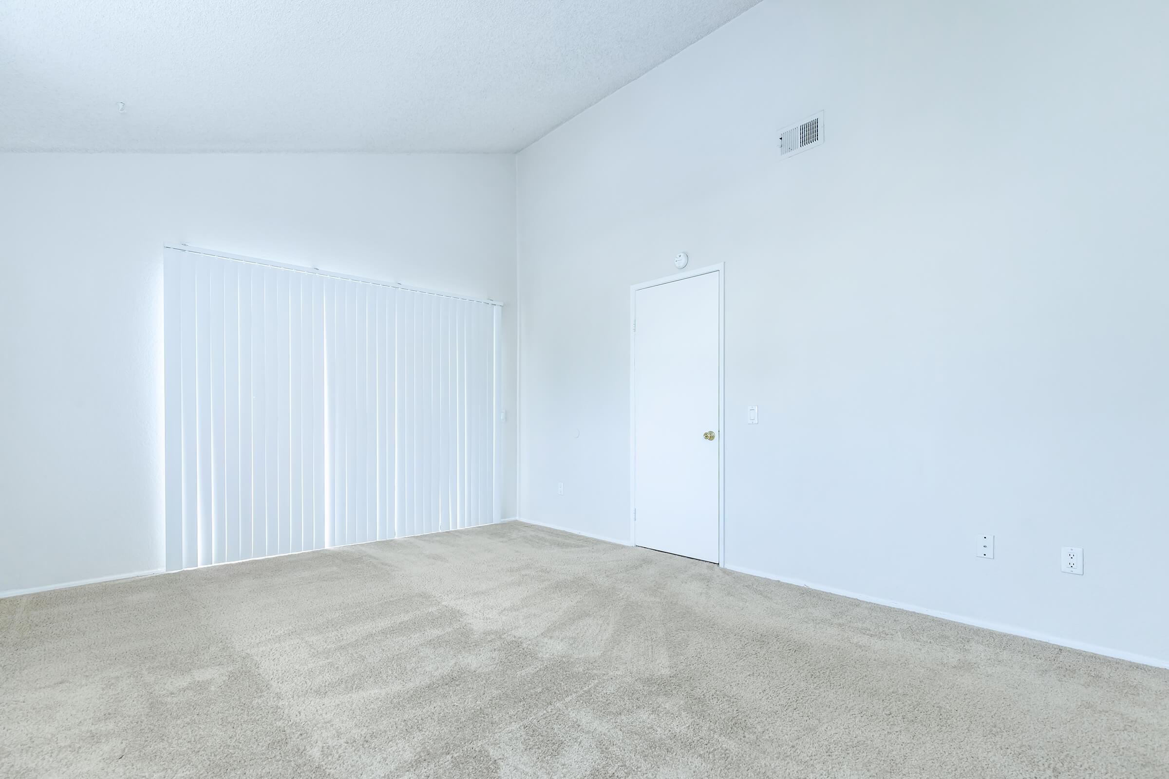 carpeted bedroom with sliding glass doors