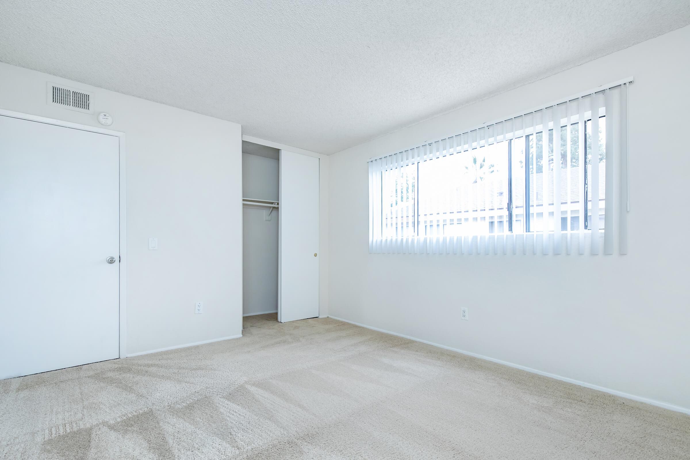 unfurnished bedroom with sliding closet door