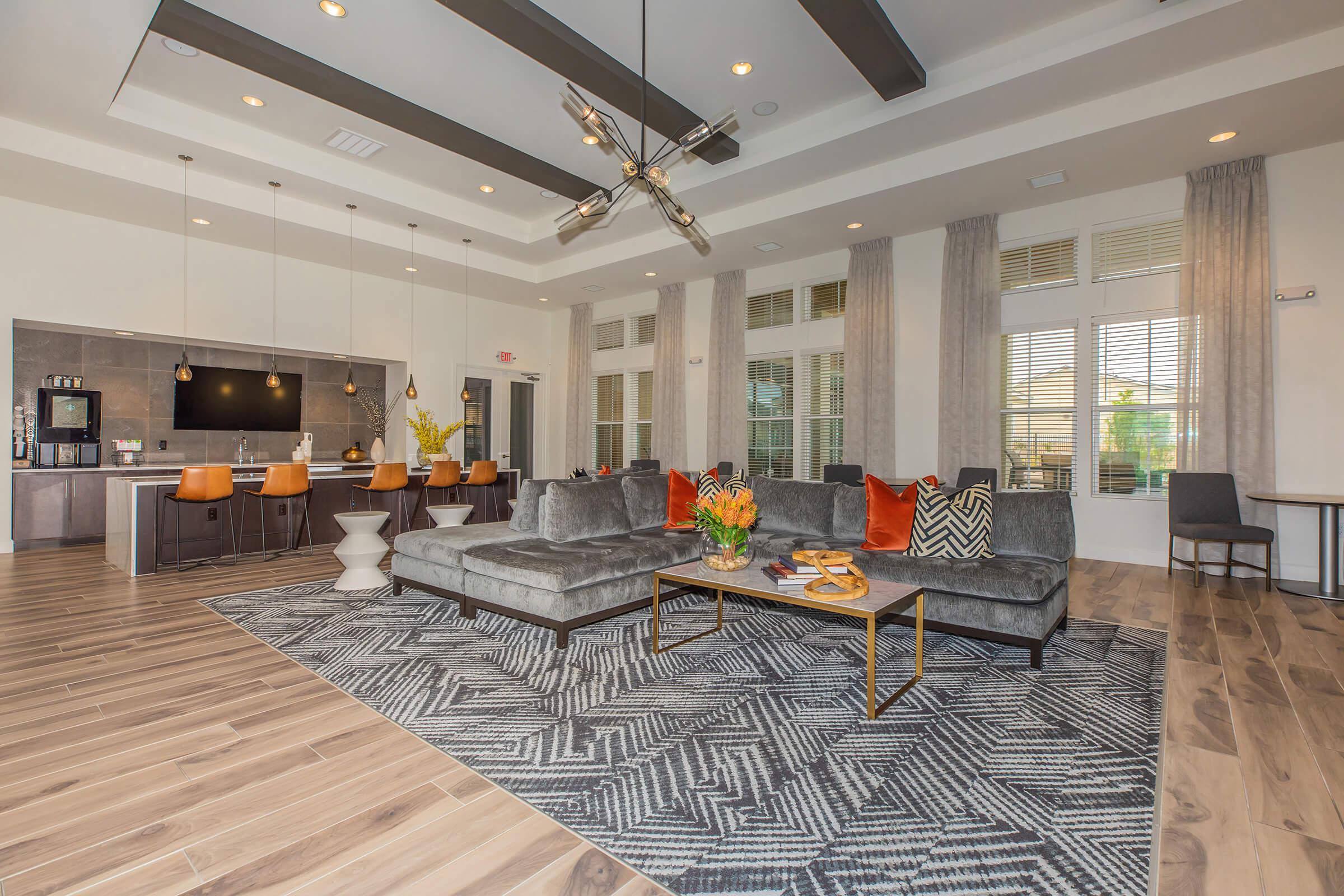 a living room filled with furniture and a large window