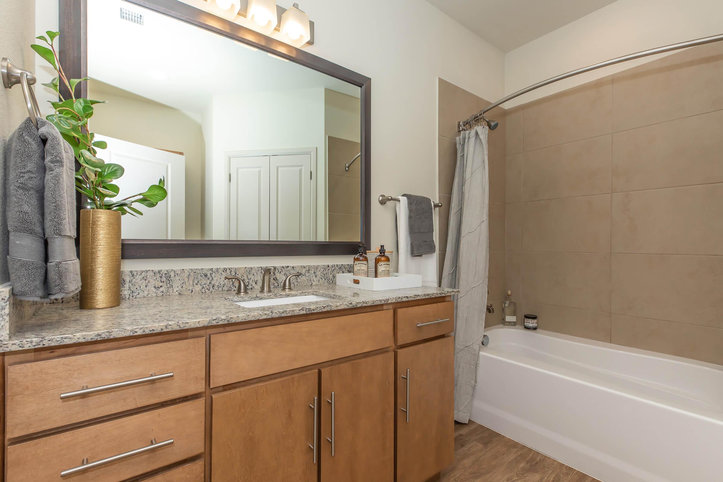 a kitchen with a sink and a mirror