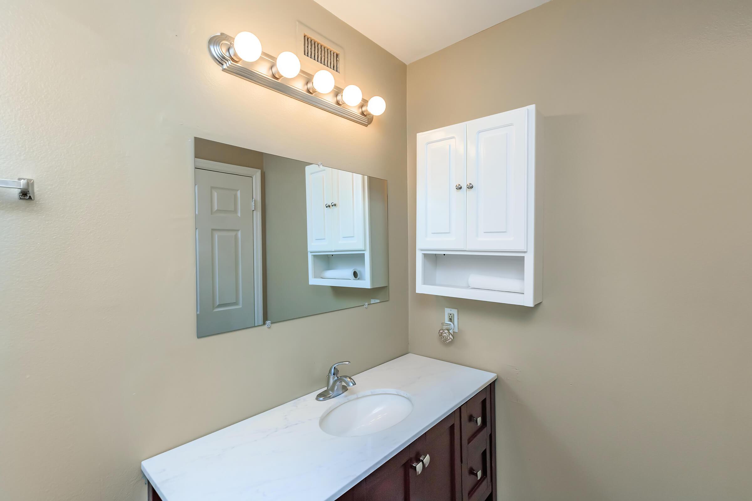 a white sink and a mirror