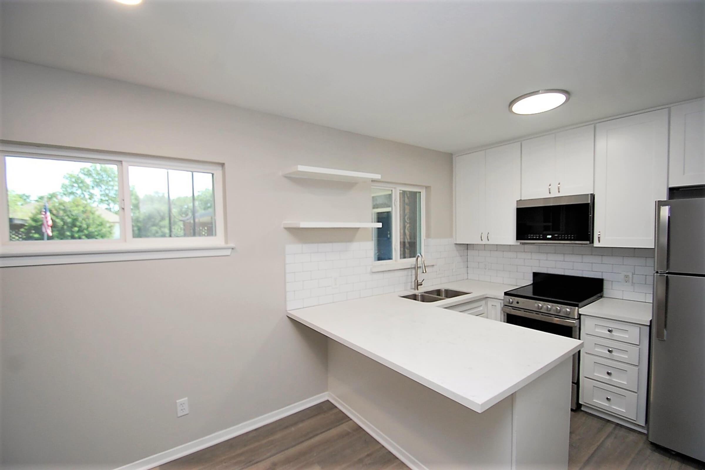 a kitchen with a sink and a window