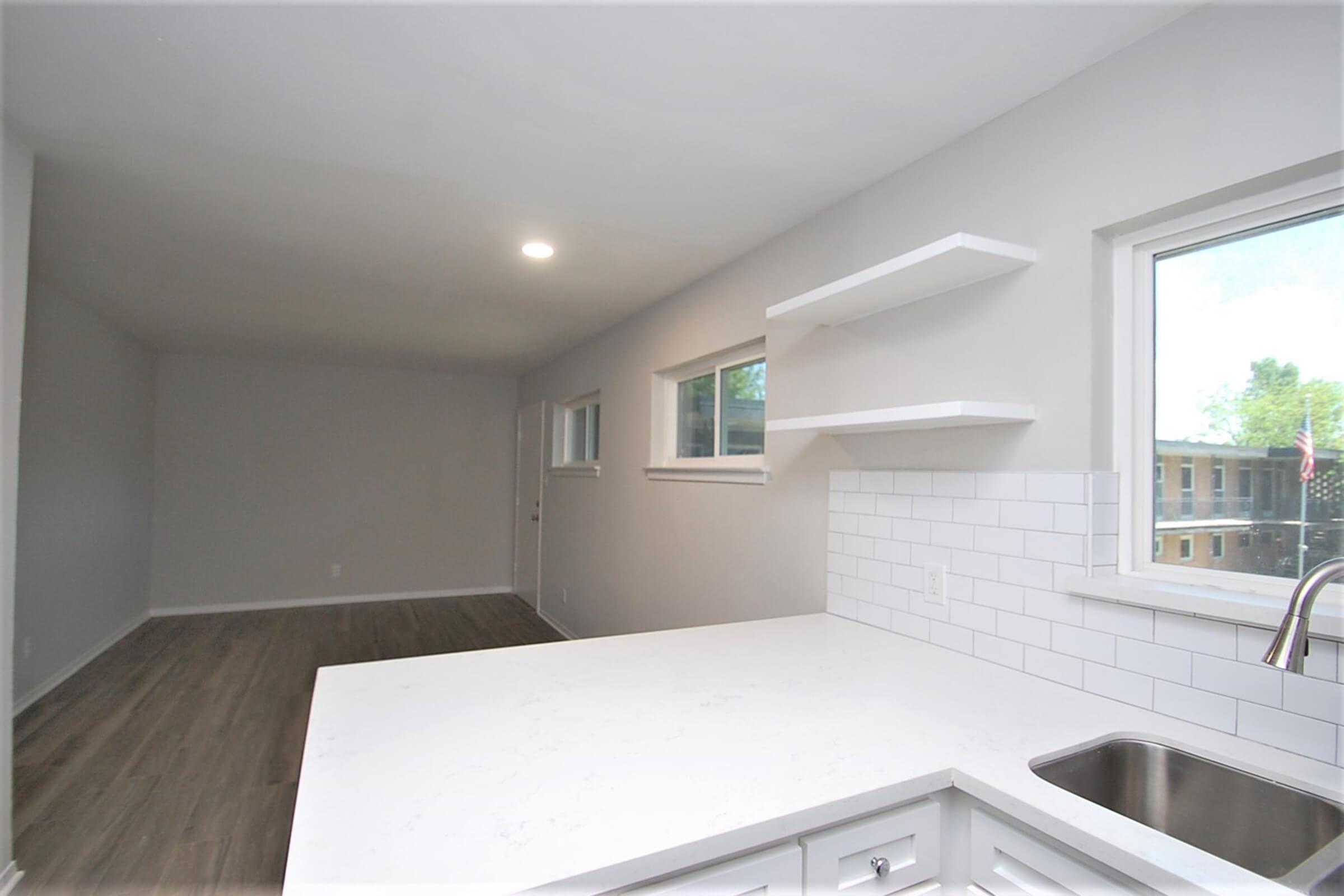 a kitchen with a sink and a window