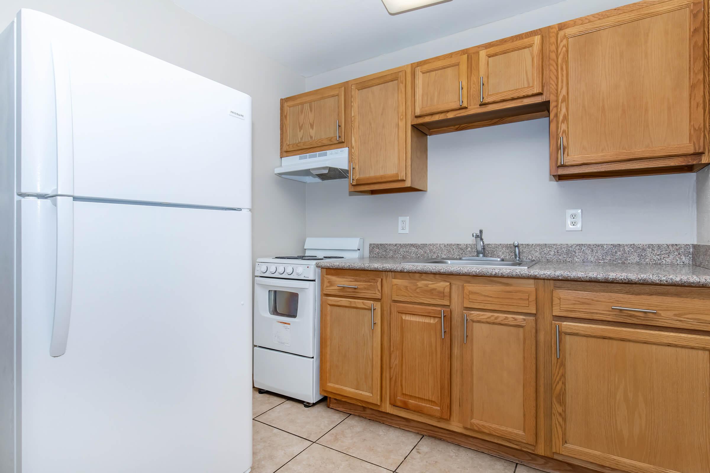 a kitchen with a stove and a refrigerator