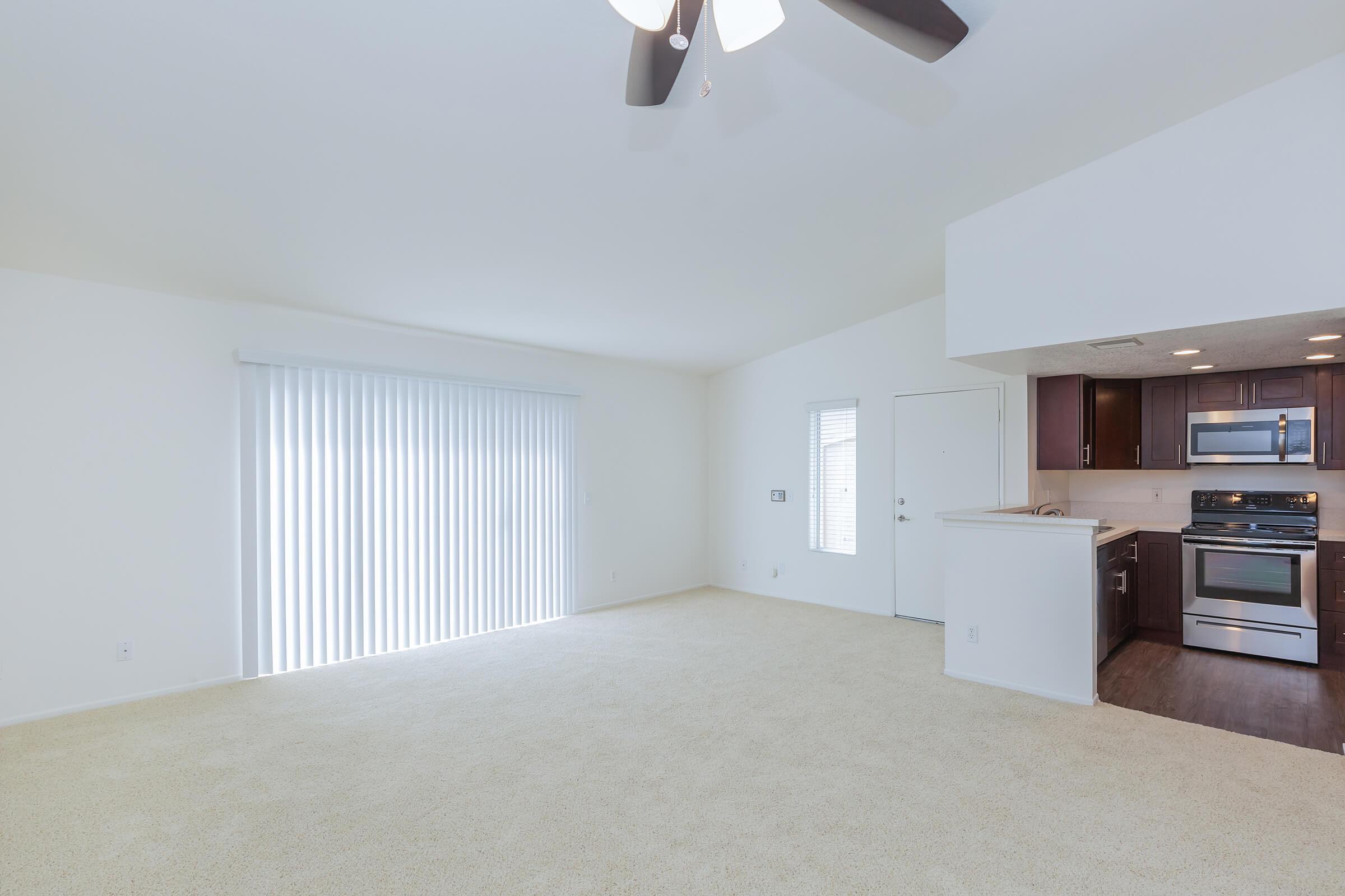 Living room with glass sliding doors and kitchen