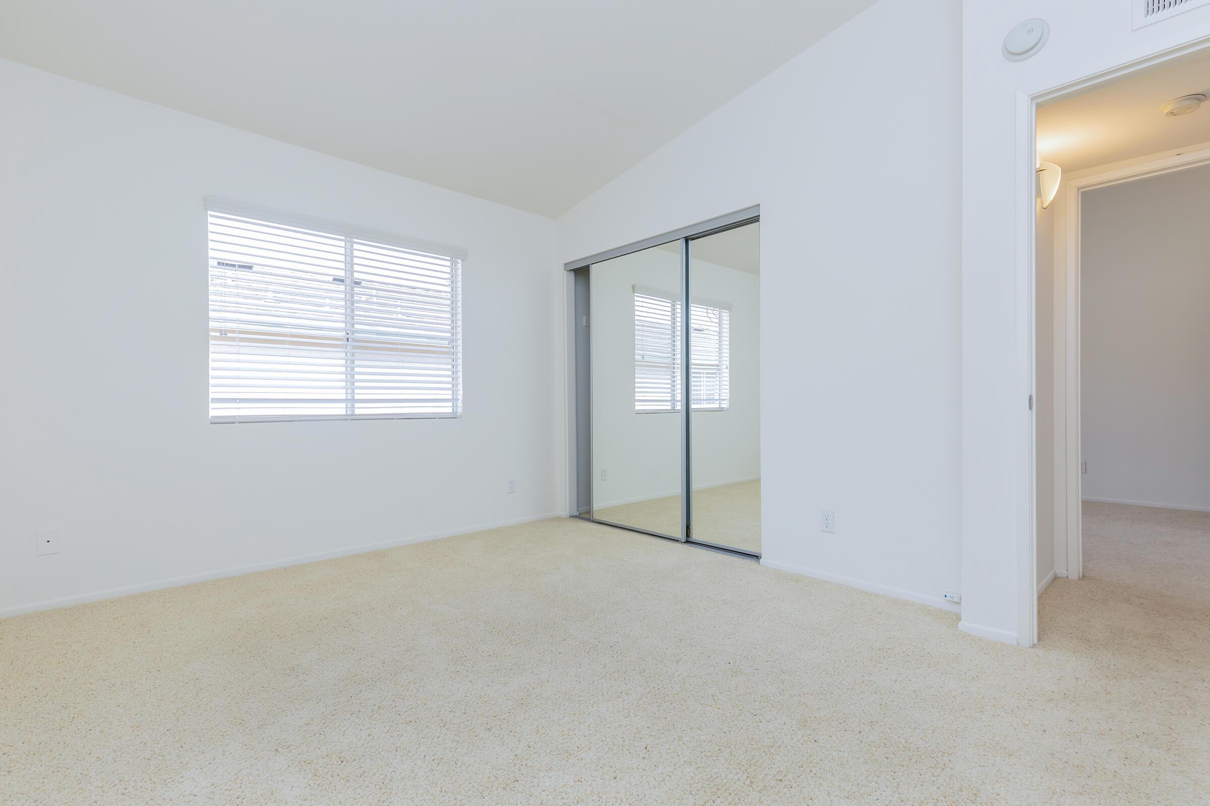 Bedroom with sliding mirror closet doors